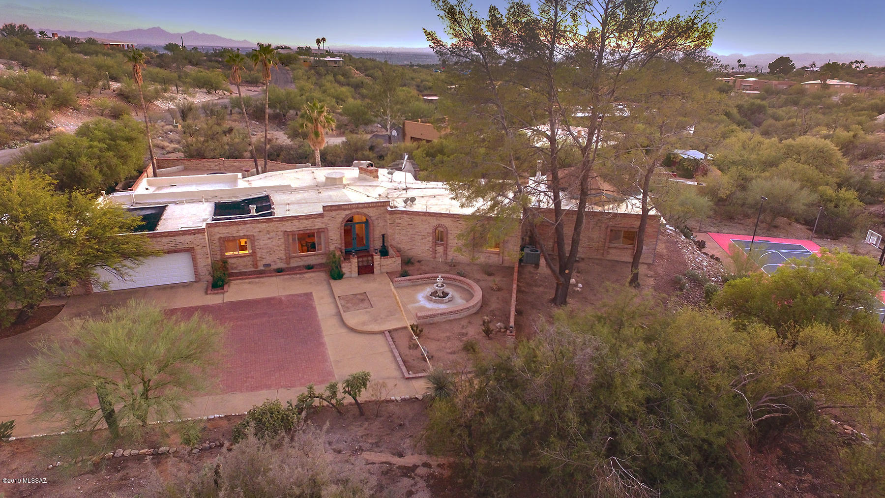SPRAWLING HOME FOR AN ACTIVE & FUN FAMILY! SPECTACULAR BACKYARD FOR ENTERTAINING, RELAXING AND PLAYING.  AMAZING FULL-SIZED SPORT COURT  IN SEPARATE AREA. OUTDOOR KITCHEN FEATURES BUILT-IN BBQ, SMOKER, SIDE BURNER, PIZZA OVEN & COUNTER LIGHTS. EXPANSIVE  COVERED PATIO, MOUNTAIN VIEWS FROM SPA THAT WATERFALLS INTO POOL. UNIQUE HOME WITH MANY SPECIAL FEATURES. SPACIOUS ROOMS, HUGE MASTER SUITE WITH FIREPLACE, LIVING ROOM + FAMILY ROOM, DEDICATED BAR AREA, OFFICE,. TONS OF LIGHT AND GLASS, POLISHED SCORED CONCRETE FLOORS. GIANT KITCHEN GLOWS WITH COPPER CABINETS & BEAUTIFUL HARDWARE. IT'S LIKE COOKING IN A RESTAURANT ON SIX BURNER + GRIDDLE VIKING RANGE, MASSIVE STAINLESS STEEL HOOD  AND LOADS OF WORKSPACE. BOTH FORMAL AND CASUAL DINING AREAS INSIDE, WONDERFUL PATIO DINING OUT. DIST 16 SCHOOL