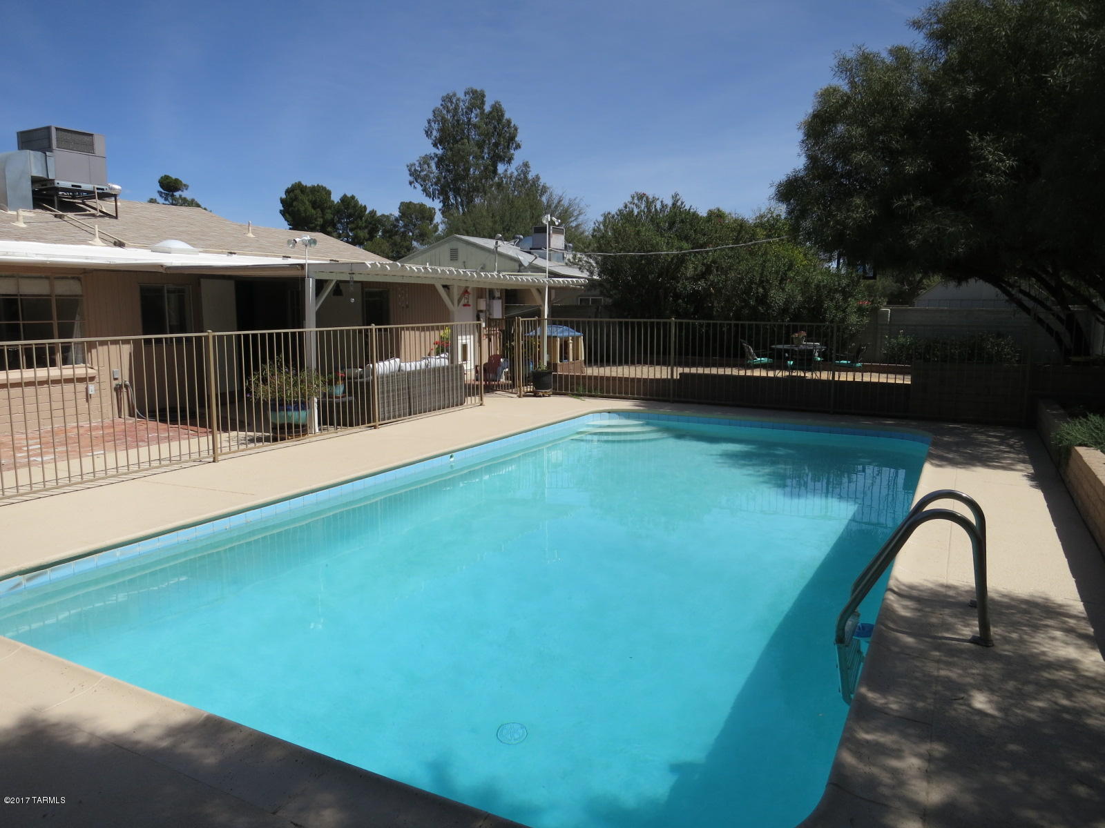 The moment you enter, you'll love this perfect 3 bedroom, 2 bath plus office 50's brick classic. This extremely well maintained home is located on a street with minimal traffic and in an area that's conveniently located to shopping, medical and other.  Features include fantastic natural lighting throughout, large swimming pool and charming backyard area, bonus room(great as activity room, den, toy room, dining), ceramic and new concrete flooring(no carpet), interior paint, cooler replaced in 2010, roof replaced in 2011, HVAC replaced in 2013, water heater replaced and pool decking painted in 2017. Storage is excellent with abundant closet space, 120sf laundry room, work shed, carport storage.