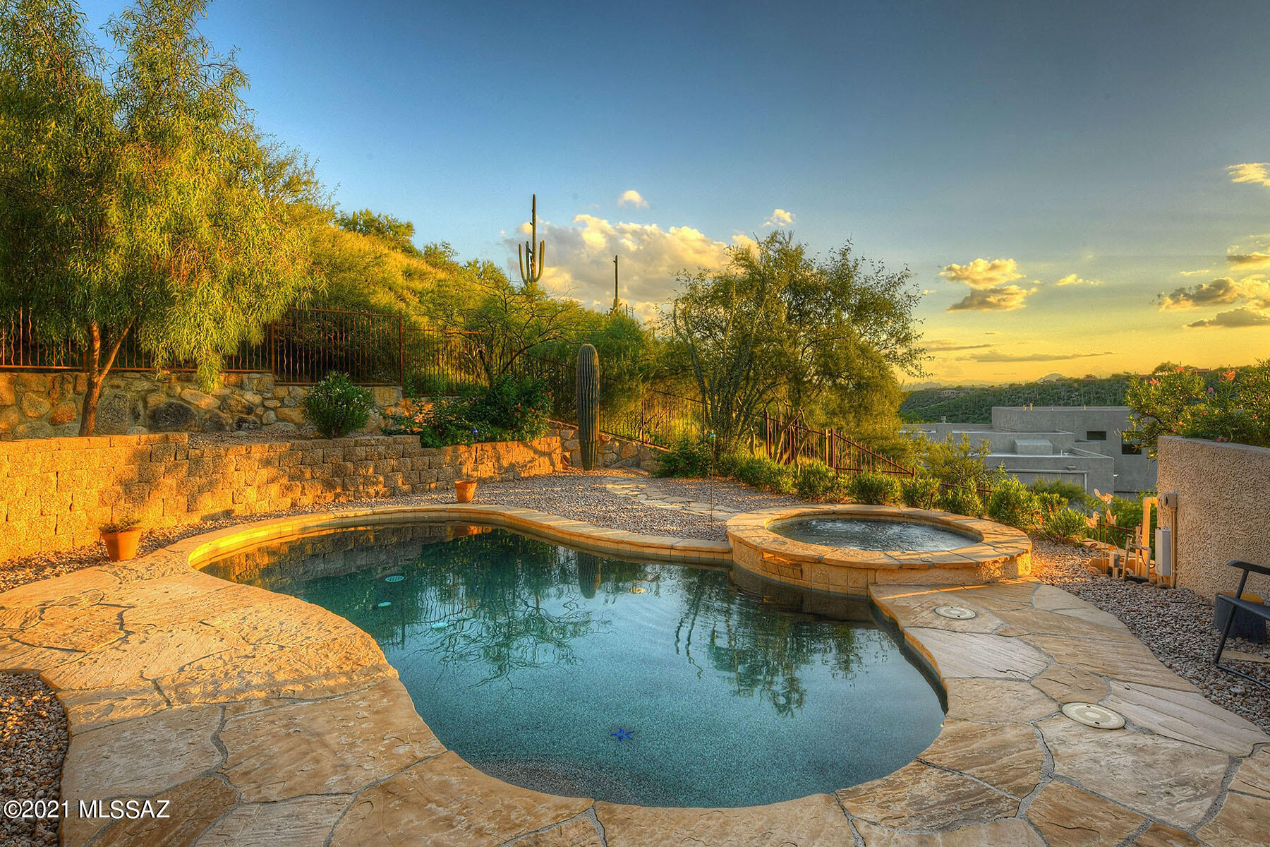 Located on an elevated 2.45 acre view lot in the Catalina Foothills, this 1999 custom-built, integra block construction home has exceptional views & privacy. This one owner home has been meticulously maintained & was built w/ quality materials including Marvin aluminum-clad wood encasement windows, Tucson Rolling Shutters, 13 KW OWNED Solar System (2 years old w/ 25 year warranty-current bills less than $21/month), California Custom Closets & Pool & Spa by Patio Pools. Little Ridge is a hidden gem neighborhood in the foothills w/ only 20 homes that is tucked away yet convenient to shopping, restaurants, Sabino Canyon & world class Golf Resorts like Ventana Canyon and La Paloma. Efficient 3000 sf floor plan has 4 bedrooms and 3 bathrooms. Gracious foyer leads to formal dining/living rooms. The east wing of the home has a large master suite with a luxurious master bath with dual vanities, gorgeous large walk-in shower, soaking tub and fabulous master closet with bamboo floors and custom built-ins from California Closets and the 4th Bedroom/Office and additional full bathroom. The center of the home is designed with family and friends in mind with a large open family room w/ gas fireplace with heatilator off of the spacious kitchen with breakfast bar and informal dining. The space is flooded with natural light from windows and skylights giving a bright and cheery feel. Sliding glass doors lead to a magnificent resort-style backyard with a deep covered patio, pool and spa. West wing of the home has 2 spacious bedrooms and a large bathroom with dual vanities and tub/shower. Spacious laundry room with storage cabinets and sink. 2-car garage with 2 large storage closets. Special features include cat 5 wiring to every room, post-tension slab, pool pump and filter replaced in 2019 and much more. Superb location within close distance to all of the best amenities in the foothills.