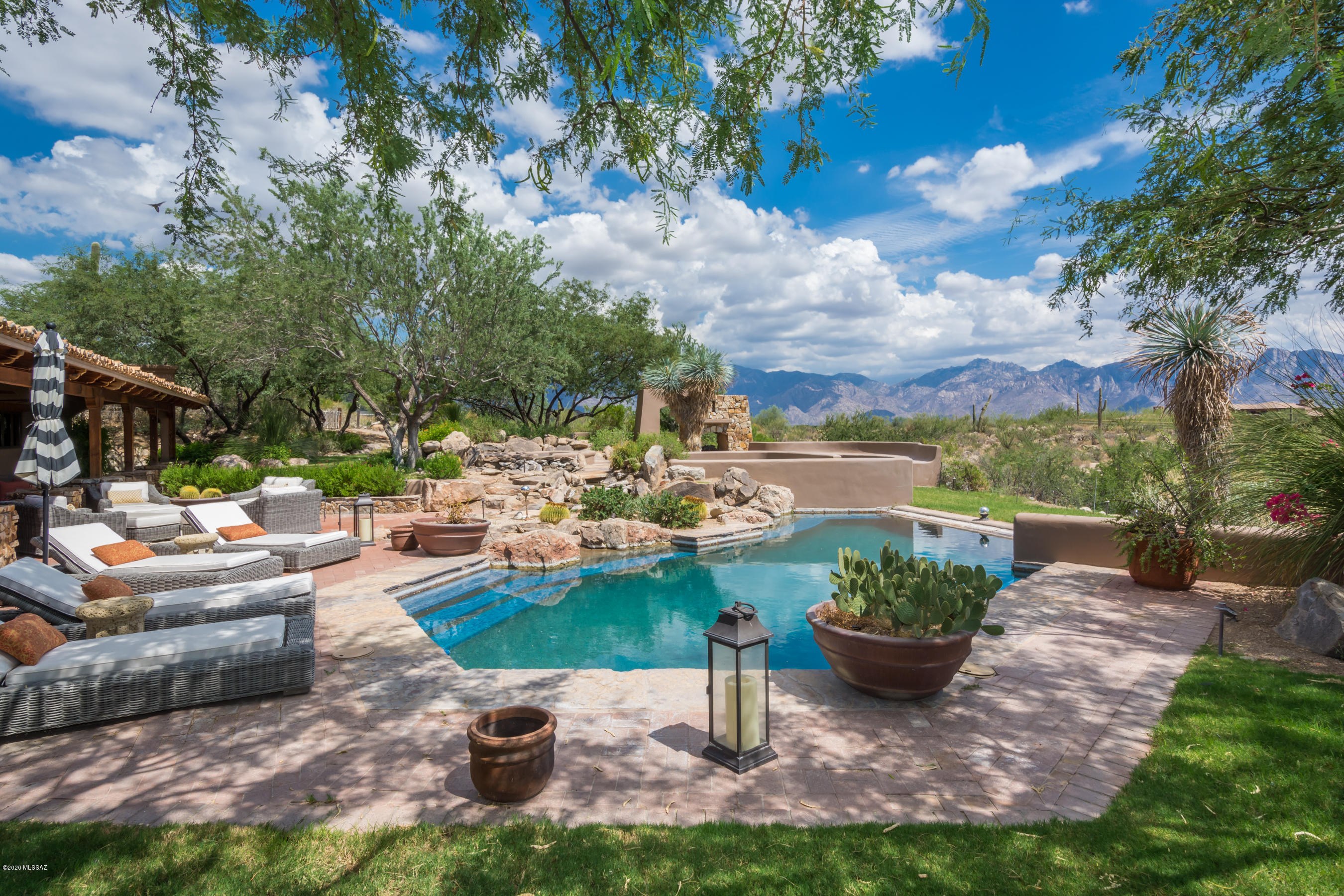 Truly a one-of-a-kind opportunity on over 4 acres in Stone Canyon.  Dramatic panoramic views of the Catalina Mountains, Tortolita Mountains, and downtown Tucson await in the mesmerizing backyard; impeccably landscaped, along with multiple water and fire features, extended covered patios, and roof deck. An oasis in the midst of Tucson's premier, guard gated community. This spectacular Hacienda has been renovated into a masterpiece of originality, craftsmanship, and luxury. Chef's kitchen, large master suite, magnificent rec room with 20'' ceilings, wet bar, den/office, multiple fireplaces, three bedrooms, four bathrooms, huge garage. Be sure to ask for a tour of Phil Mickelson's Stone Canyon Club amenities, including the highly ranked golf course, fabulous clubhouse and restaurant, and... exceptional fitness and recreational facilities.