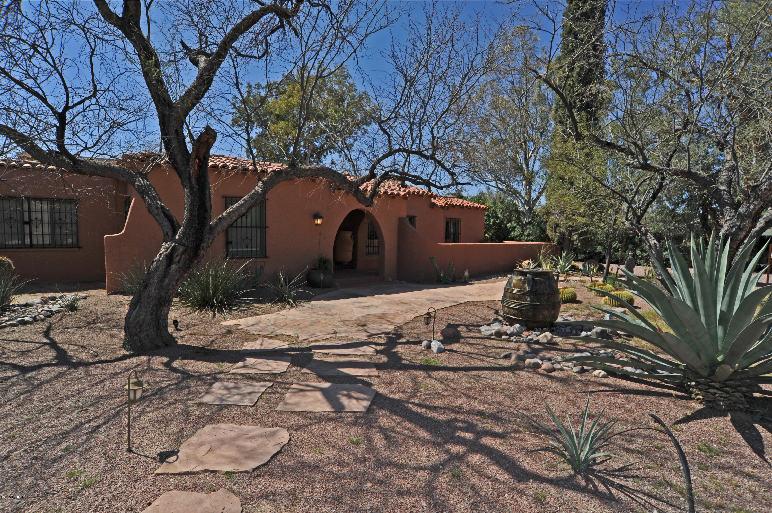 1930 Joesler in Colonia Solana on the Historic Register. Original wood & concrete floors. Main house, 4 bed 3 bath, fireplace in living and master,  beamed ceilings, plus family room two dinning areas. Guest House so charming with 2 bedrooms 1 bath plus additional separate Studio and office. Great compound for all your living needs. Carefully updated with Venetian plaster, new vintage inspired tiles and fixtures. Designer touches throughout. Over one acre, lushly vegetated with cacti and GIANT trees. Plenty room for parking additional vehicles, RV, boat? Great Value , low taxes. Close to the University and the down town happenings. 4167 combined sq. ft.