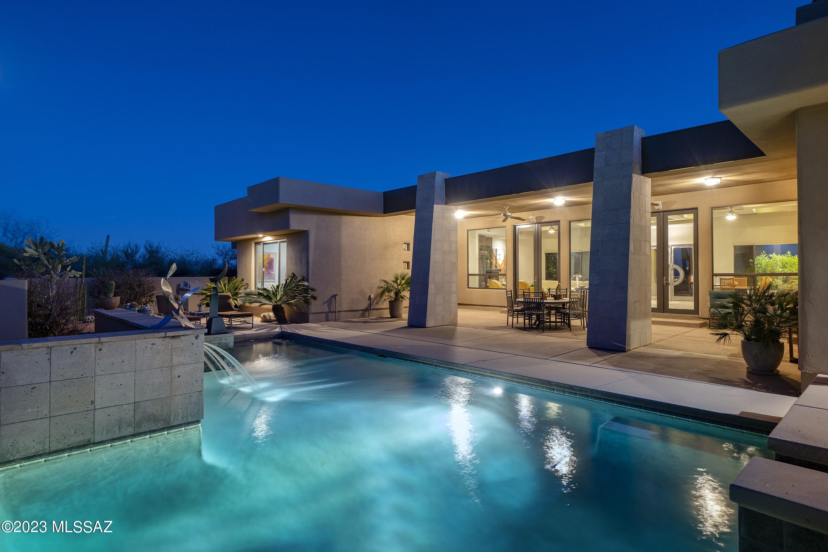 This sophisticated residence, located in the highly sought after Pima Canyon community, epitomizes luxury living at its finest. Upon arrival, one is greeted with a timeless elegance and impeccable attention to detail that defines this stunning residence. The entry foyer sets the tone, with soaring ceiling heights and exquisite architectural form and function that showcases the home's unique and contemporary design aesthetic. The spacious living room has been carefully curated to create an exceptional living experience, with floor-to-ceiling windows that bathe the space in natural light and provide breathtaking views of the surrounding desert landscapes, with unobstructed Catalina mountain views beyond. The floor plan comprises both formal and informal living spaces, equally suited for scaled entertaining, as well as quiet moments. A chef's kitchen boasts a large center island, custom cabinetry, ample storage, as well as functional natural stone counter space, where every measurement and detail has been carefully considered to enhance the user's experience.

Retreat to the luxurious primary suite, a private sanctuary of comfort and style that features a spa-like bathroom, spacious walk-in closets, and picture windows that frame the stunning views and lush grounds. A secondary bedroom suite/office is available just off the primary that is both generous and bright. Situated on the West wing of the residence, and perfect for guests or family alike, are two supplementary bedrooms discreetly sequestered and offer direct access to the backyard's covered veranda, pool and spa.

Outdoor living spaces connect seamlessly, each having been thoughtfully positioned for entertaining, while overlooking the resort-like pool and elevated spa, both elegantly and effortlessly nestled within the space. This home and property offer the perfect blend of luxury and privacy, with easy access to the best dining, shopping, hiking and entertainment that the area has to offer.
