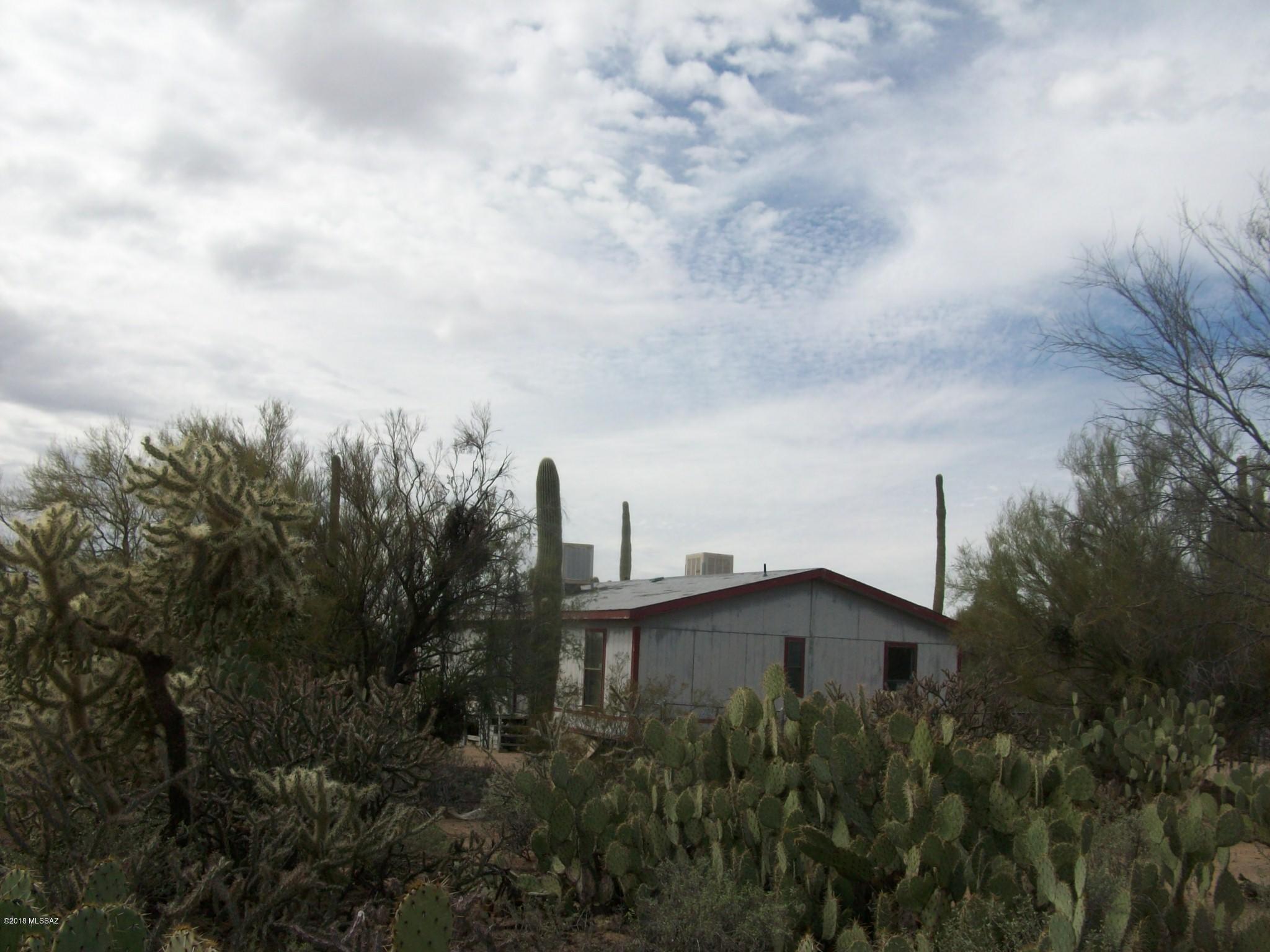 This is a 1988 double wide manufactured home on 1.016 acres, 3 bedroom, 2 bath - down a private easement - fenced and gated in Picture Rocks. Priced for quick sale.