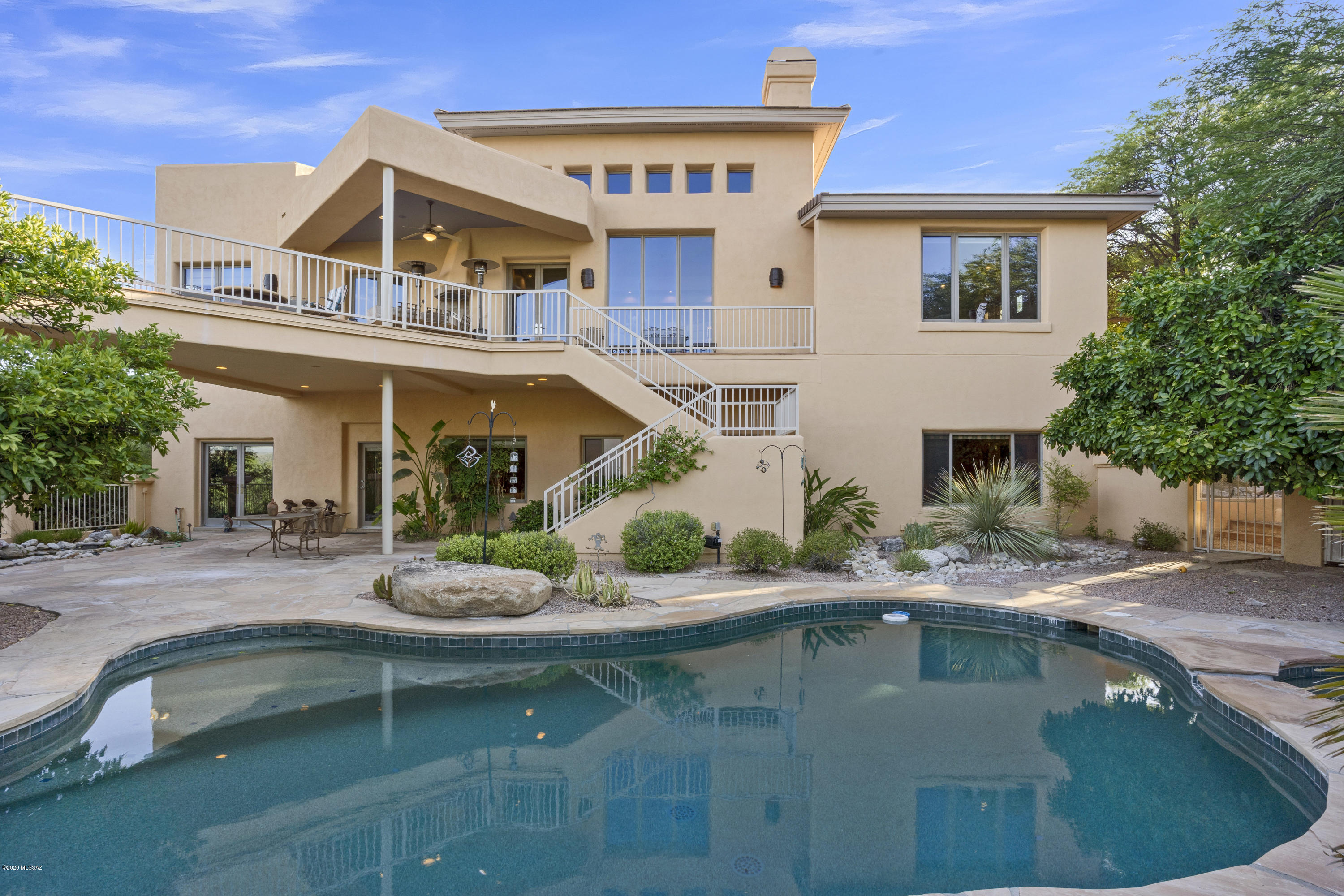 Welcome to true luxury and comfort in the heart of prestigious Ventana Canyon! Tucked away and distinctly private, this estate welcomes you with soaring ceilings, walls of windows, and commanding views of the Santa Catalinas and the world-renown, championship golf club! Step through the showpiece living room onto the extended view deck and take in 180 degree views and all the natural beauty of the Sonoran Desert! Inside, the master suite is expansive and a true retreat including travertine accents, luxurious soaking tub, and mountain views galore. Like to entertain? This home is built to host with a chefs kitchen sure to make the most discerning guest grateful! Don't miss the private pool, downstairs bedroom suites, outdoor kitchen, walking trails, and so much more. Simply perfection!
