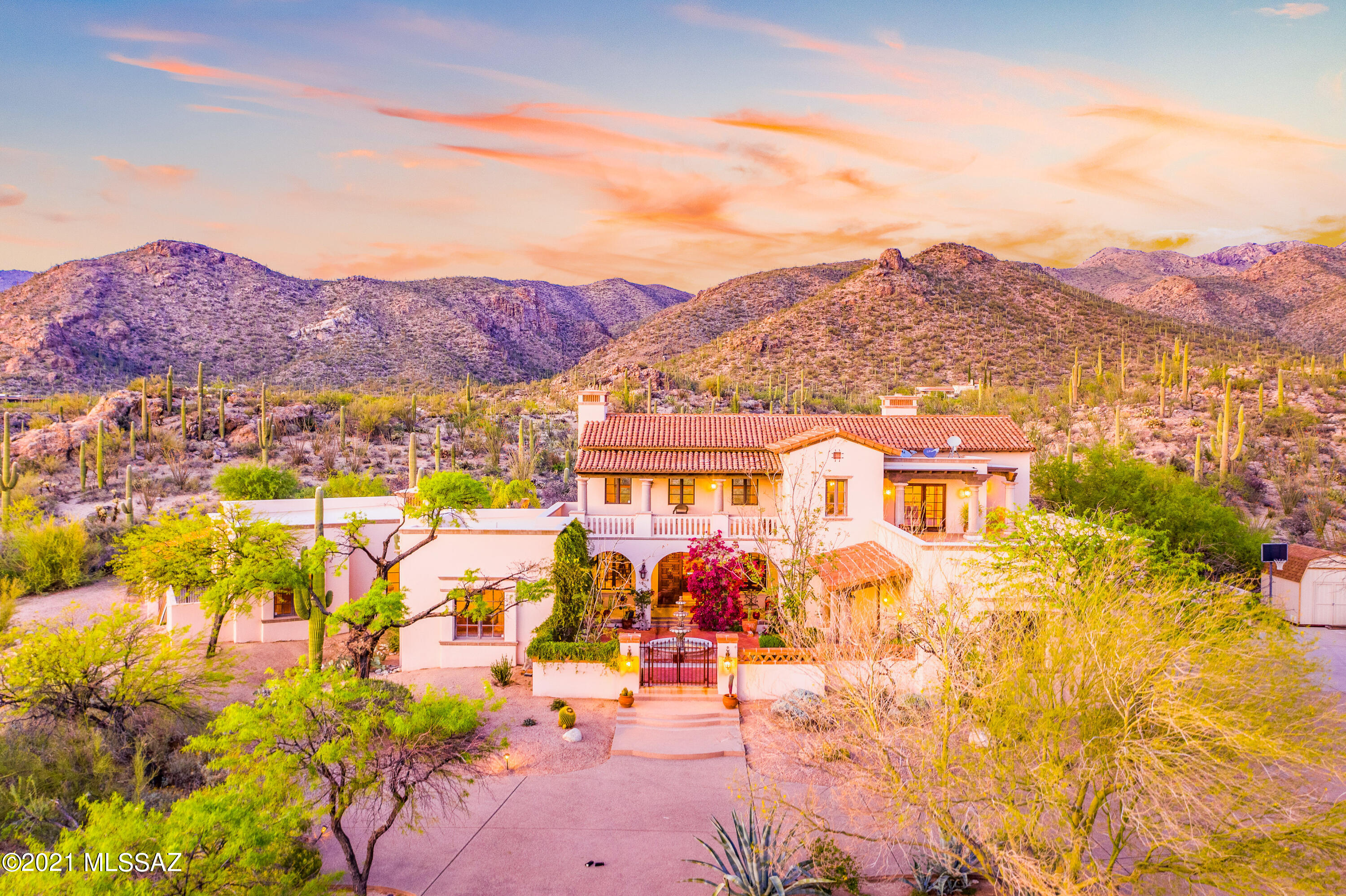 Exquisite, privately gated Santa Barbara style estate w/ UNOBSTRUCTED mountain views located on 5.77 acres of pristine, saguaro-studded land in the lush & tranquil Tanque Verde Valley. Live in complete privacy & seclusion on a  cul de sac at the base of the Agua Caliente Foothills. Enter through a spacious courtyard w/  a beautiful fountain into this 5 bed/ 4 ba, Rastra block home.  Dramatic 23 ft beamed ceilings in great room are complimented by a wall of enormous windows to capture the unobstructed mountain views. Formal dining room, cozy family room w/ FP & gourmet kitchen w/butcher block center island. Gracious en-suite bedrooms downstairs.  Upstairs master suite w/ FP., huge master bath, loft/library area, separate office and balcony w/ gorgeous views of the city & mountains-Mo Backyard w/magnificent views, large turf area, pool and spa. Built-in BBQ and plenty of dynamic outdoor spaces to enjoy the views from this special property.  4-car garage. Current owners added an 802 sf  heated and cooled bonus/hobby/workshop where 2 of the 4 car garages are located. Roof-top deck to capture city lights.Top rated Tanque Verde Schools within close range.  49ers Country Club within 5 minutes for Golf, Swimming, Restaurant and Brand New Fitness Center. La Mariposa Tennis and Fitness Club also nearby. Incredible hiking and biking in every direction.  Saguaro National Park East, Mount Lemmon and Redington Pass are just a few of the incredible places to enjoy the outdoors. Tanque Verde Guest Ranch within minutes.