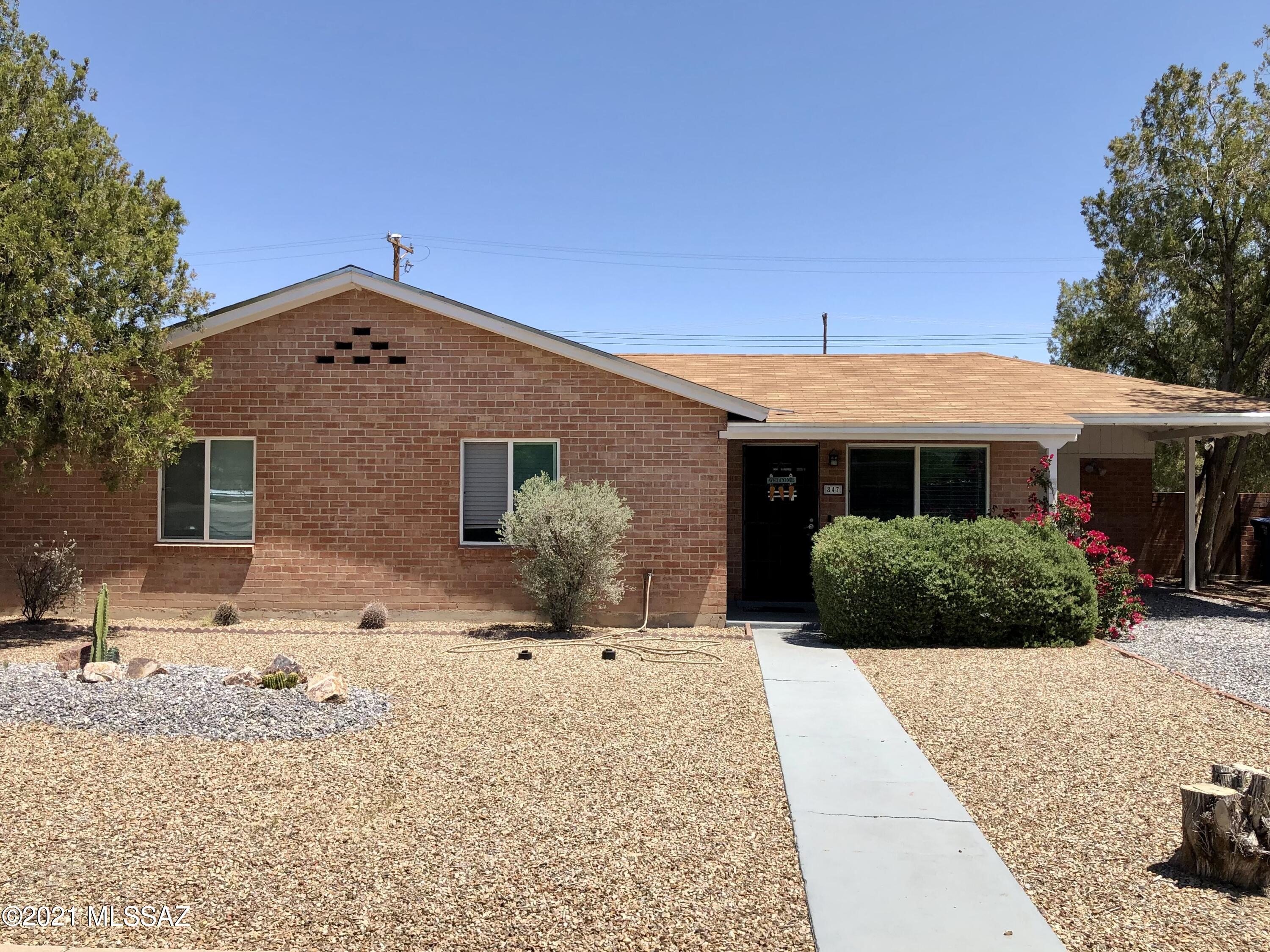 It'll be love at first sight when you step into this beautiful 3 bedroom, 2 bathroom brick home in central Tucson. The brick construction gives this home so much character but the inside also offers much to look forward to. This home boasts a granite counter top kitchen with decorative modern black tile backsplash, stainless steel appliances, dishwasher, deep sink and plenty of cabinet space and pantry storage. You will love the living area which has windows surrounding the space and invites a lot of light to come through. New window shutters just installed! The backyard has been upgraded with pavers, grass, and a wood/stone Ramada which is perfect for entertaining guests, letting the kiddos play and letting your pets roam comfortably. There is so, so much more, come see for yourselves!!