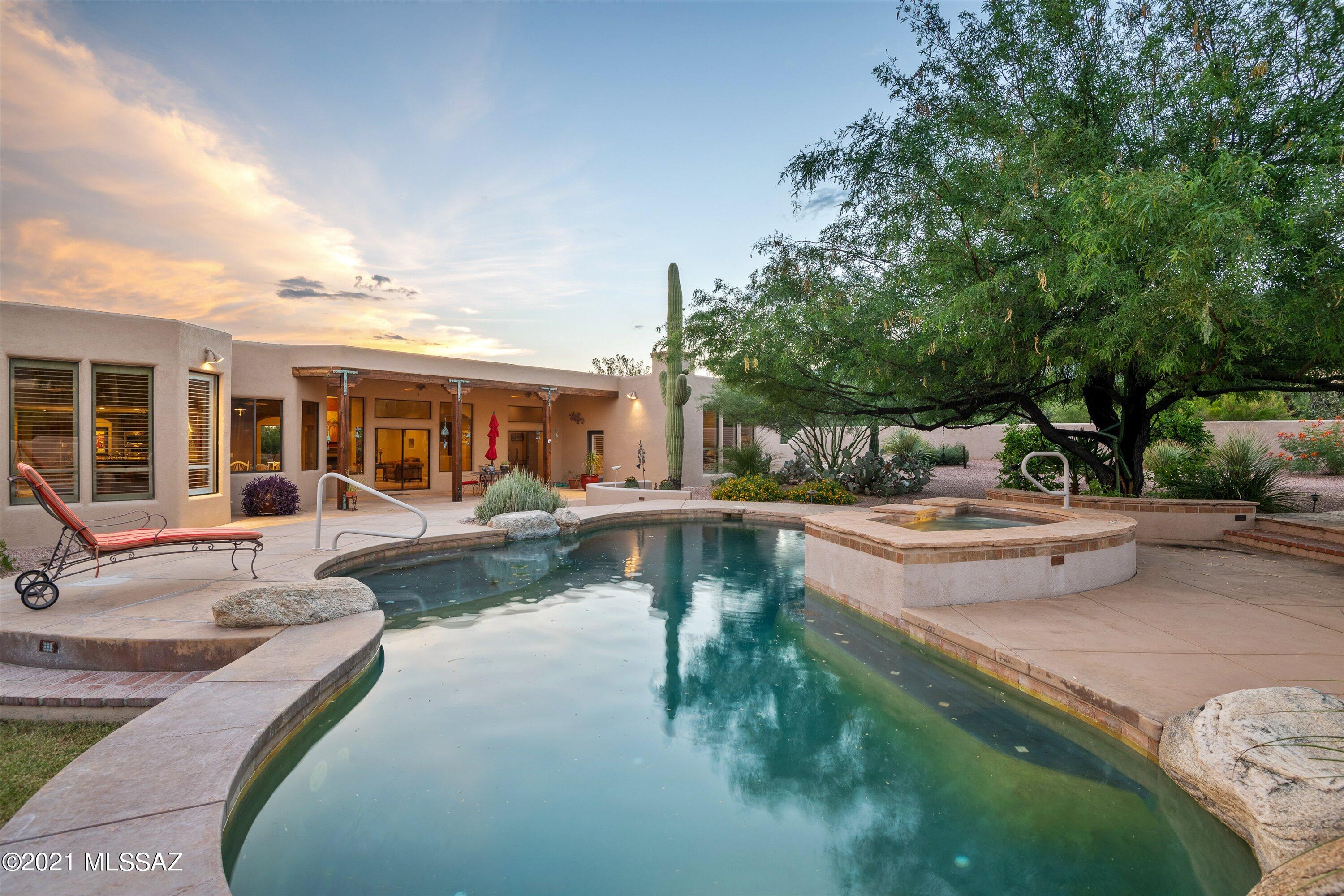 Exceptional Santa Fe custom home located in gated foothills enclave of Canyon View Estates near Sabino Canyon. This 3705 sqft 4bed/4bath home sits  on a 1.31 acre lot with stunning views of Catalina mountains. Family room with wood ceilings and a unique wood burning stone fireplace. Gourmet kitchen with a large round island perfect for friends and family gatherings. Breakfast nook open to the family room, patio and pool with incredible mountain views. Large master with wood beam ceiling and Beehive Fireplace and mountain views. Master bathroom features his&hers walk-in closets. Experience an Arizona outdoor living surrounded by lush, private Resort-like backyard. and Sparkling pool. Large patio with wood ceiling, 
3 oversized garage,