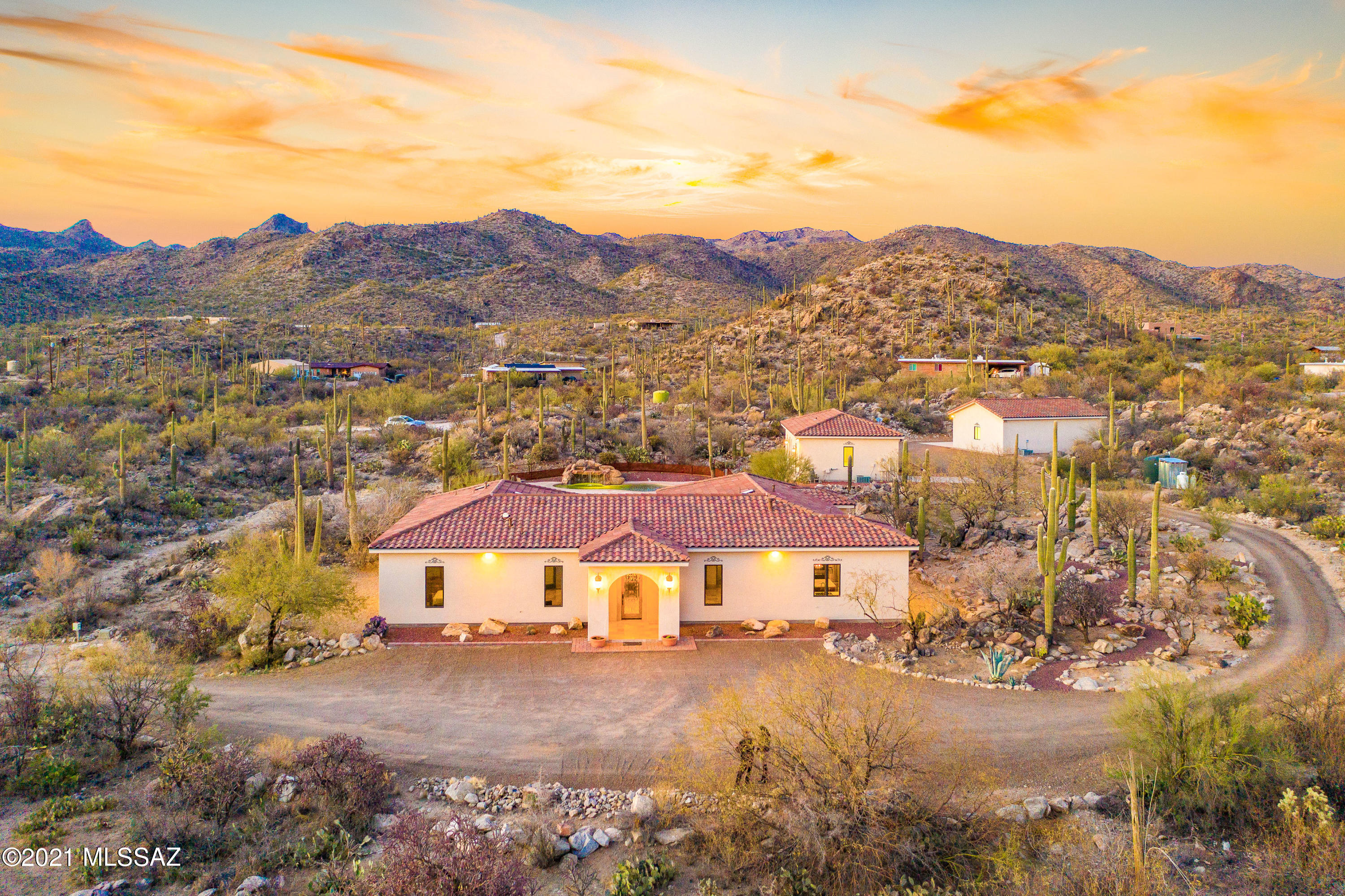 Your Private Desert Domain awaits nestled in 5 private, Saguaro studded acres and surrounded by sweeping views of the Tortolita Mountains! Complete with private gated entry, a 3Bedroom, 3.5 bath plus office  2937 sq ft Main home, a 648sq ft Guest home with kitchen, bedroom, bath , living space and attached 1 car garage,  refreshing and amazing Pebbletec pool with Grotto and Waterfall and a detached 3 Garage w/workshop space that is heated and cooled!! Se Extensive spaces for all your toys, RVs and Horses.  Sellers have lovingly maintained the homes and improved well, septic and filtration systems aside from many more details. Need I say more? Let me get into the details.  Enter your private driveway and instantly feel submerged in the gorgeous desert.  A Grand Mediterranean home with doubl 2x6 construction, fully insulated, and quaint red tiled roof greets you. As you make your way in your new home, you are captivated by the view from the new huge picture window towards the courtyard and pool area.  Freshly cleaned/sealed and stunning Travertine floors cover all main living areas. Fresh interior paint screams move-in ready!  A large built-in for your TV and mementos is sure to please.  Your Great room is light and airy.  Your Enviable and Charming Chef's Kitchen is high quality with dovetail construction, soft close doors/drawers, tons of pullouts, Miele warming drawer, custom hood, 5 burner Gas cooktop, Durable Marble countertops, Walk-in pantry. Reverse osmosis system under sink and additional one above fridge for water/ice maker. Adorable breakfast nook seating with vintage table serves as a set for many family memories.  Owner's suite is grand and private and has new carpeting.  His/Hers set up for vanities, toilets, walk-in closets are brought together by an impressive walk through Travertine shower. This is a setup fit for royalty! On opposite side of Great room, find two bright and spacious  secondary bedrooms with en suite facilities and new carpeting. Also, a substantially sized bonus room- office, artist studio, library, rec room... super flexible space to help you adjust to current changing times. Bonus room has access to back courtyard.  All windows have been UV tinted. Let me take you outside now. Enjoy cool evenings in your stylish back courtyard, turn on the misting system and light up the night with the Edison string of lights. Back patio has been safety-proofed with sturdy and stylish steel critter fencing and totally fenced in for the kiddos and pets! Be lulled by your pool's Waterfall sounds and swim under the Grotto for a cool experience.  Experience a unique sunset every evening with front row seats from just about anywhere. Need space for your older children, parents, family in general? Or you may need a separate space for a home based business.  Take a look at the Guest house!! Double door main entry,  NEW full kitchen, private bedroom/bath and living area.  Side door takes you to an attached 1 car garage where you find the laundry- new washer/dryer. All new plumbing and venting. Designated water heater and HVAC. Guests have access to pool area.  Just a bit further down, we find the detached 3 car garage. Your walk there will feel like a stroll at one of our parks! Heated and cooled, workshop area with cabinets/benches, fans and huge TV seal the deal. Set up for air compressor system in place. Large outdoor sink and shed just around the back of building. Property has a back gate as well- trash pickup in this location.  Main system upgrades: For Well- new booster pump, new outdoor well pump 2HP in-ground pump. For Septic- New system aerator and system control panel. New leech field/drip field replacement and aeration upgrade. Warranties on invoices available to new owner. Termite treatment- Sentricon in-ground system w/warranty. For Water filtration- 2 new multimedia filtering systems & purgable sediment filter. One installed in utility closet with water softener and the other one by well tank. Propane tank- New larger tank.  These are huge expense items, so rest assured homeowners have safeguarded these systems for many, many years to come.  HVAC systems have been on regular maintenance and have a 2yr plan through 04/22. All you have to do is bring the moving trucks and you are off to living life to the fullest in your new Desert Dream!
