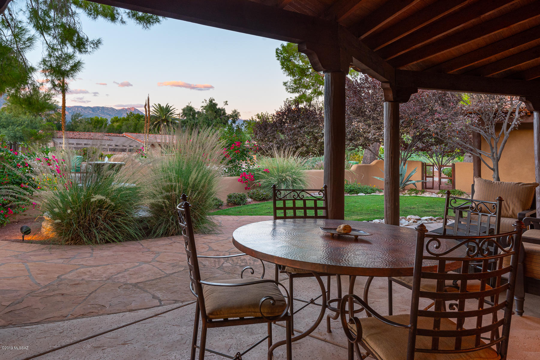 Rare 2006 sw contemporary residence located within the gates of highly-desirable Tucson Country Club. Every inch of this 4354 sf mn house & 425 sf guest house is covered w/ the highest quality materials & finishes.  Mature trees compliment this impeccably maintained home w/circular driveway, courtyard entry w/tiered fountain, covered patio & stunning mountain views. Enter through massive glass & wood double doors into an impressive entry w/ iron accents & gracious formal dining rm.  Great rm w/ soaring wood-beamed ceilings, scored concrete floors & stacked stone fireplace is open to the truly exceptional chef's kitchen w/substantial granite center island w/breakfast bar. Custom knotty alder cabinetry, travertine backsplash, SS appliances, 2 wine coolers, under counter microwave SEE MORE