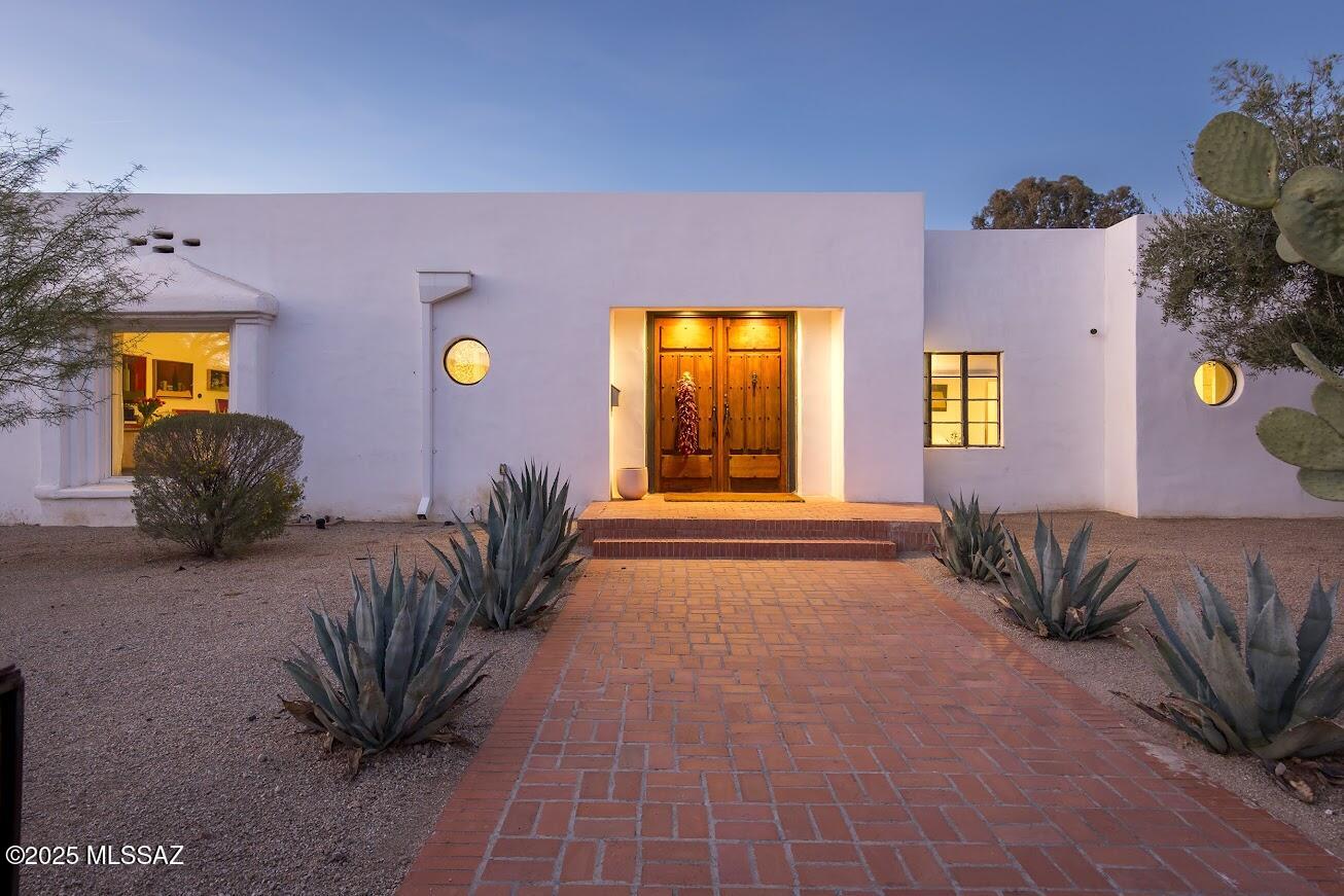 Stunningly remodeled historic adobe home & casita in historic Blenman-Elm on a double corner lot, with enough space for family & guests, and style that shows exquisite taste. Built in 1937, with hardwood floors, soaring ceilings, four bedrooms, 5 baths, remodeled with no expense spared. This home will impress your buyers looking for something warm and livable, light-filled and stylish. Taken down to the studs, all new electrical, plumbing, re-visioned rooms and floorplan. Additional thought given to the future: plumbing and electric run to the east side of the home for a second primary, gas added to the kitchen, behind the top-of-the-line induction and convection range.  A sparkling heated pool was added to the backyard. Owned 10.6kw solar system, upgraded 400 amp panel. A modern treasure