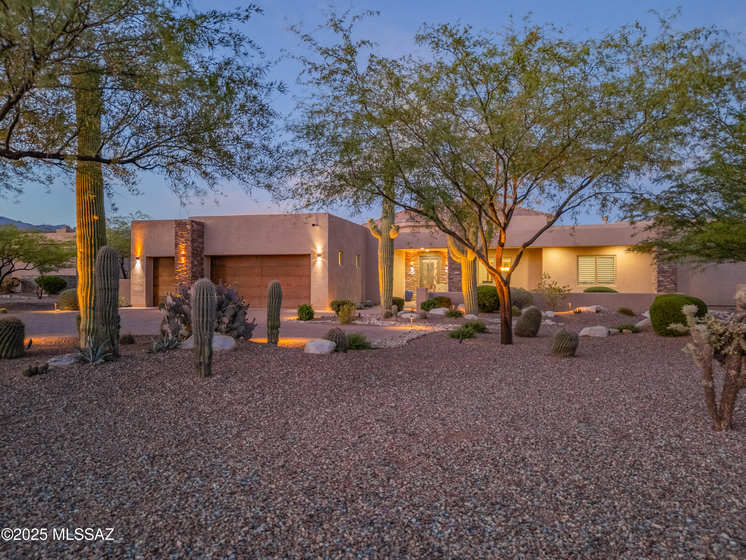 Solitude and unsurpassed Catalina and Rincon Mountain views are yours to enjoy in this 1.38 Acre homesite in gated Rancho Soldados. Block paved drive flanked by meticulously maintained desert plantings sweeps around to the covered entry and custom wrought iron front door of this dramatic Soft Contemporary. The Great-room is the heart of this home spanning 28' including the breakfast are and opens to the gourmet island kitchen. Walls of windows make their own statement capturing the panoramic mtn vistas.  Ease of use auto shade controls, new high end wood-look laminate for a 'softer than tile' surface. Luxurious kitchen amenities include oversize island, built in Kitchen Aid refrigerator, professional 6 burner gas range w/griddle, 2 ovens,  pot filler, and wine chiller.  (cont'd) Spacious primary suite: gas fireplace, jetted spa tub, dual walk-in closets, dual vanities, and mountain views. Adj. br currently is being used as a workout room. Two en-suite brs are in a separate wing. Den/office could be br 5.  Highly coveted East/Northeast facing yard featuring deep covered patio/ceiling fans, sparkling pool, and spa(with waterfall) perfect for viewing the moon rise over the Rincons.  Oversized laundry room with soak sink and cabinetry.