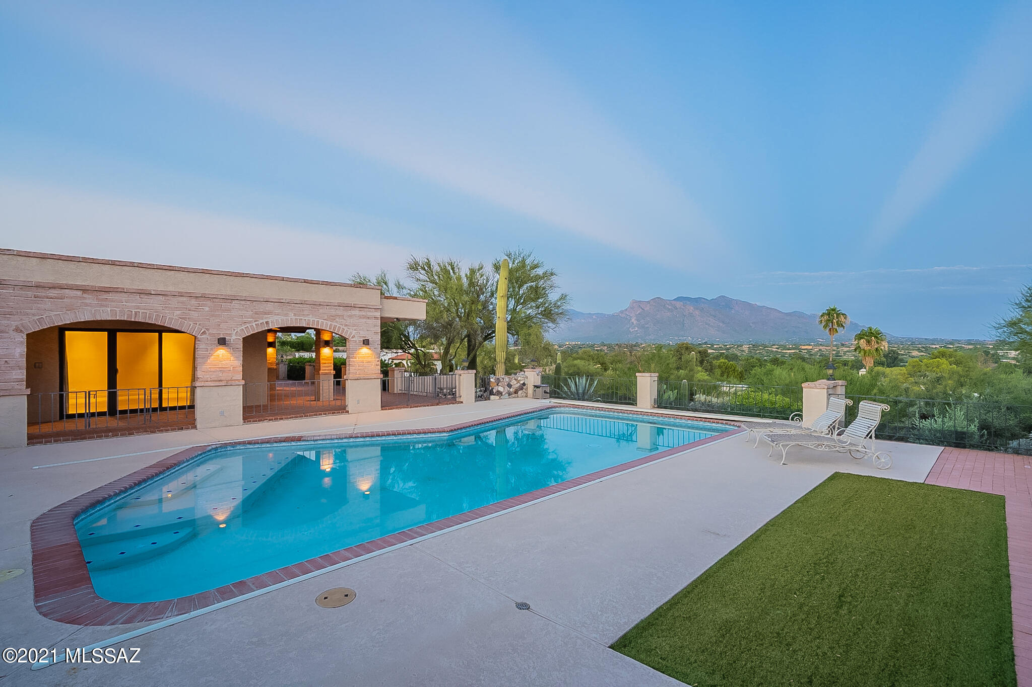 Panoramic Mountain, City, & Golf Course Views From This One Level 4 BR & 6 BA - 4,089 Sq.Ft.Solid Brick Home In Tucson National Estates.Originally Designed & Built by Notable Architect David Fraker. This Timeless Home Features Travertine Floors,Living & Dining Rm w/Wet Bar,Family Rm w/Stone Fireplace & Custom Bookcase,Spacious Island Kitchen, & All En Suite Bedrooms (4th BR/Office Offers Custom Built In's). A 2008 Remodel Added Another BR & BA,New Windows & Doors,Laundry Rm,Cedar Closet,& Oversized 3rd Garage Bay.Expansive Outdoor Living Spaces Include a Front Courtyard Entrance w/Covered Entry,Front Yard w/Citrus Trees,Covered Patio Off Kitchen,Covered Patio Wrapping Around the Entire Back of House, & a Spectacular Pool Area w/ Dedicated Pool Bath,Ramada,& Sweeping Mountain & City Views!