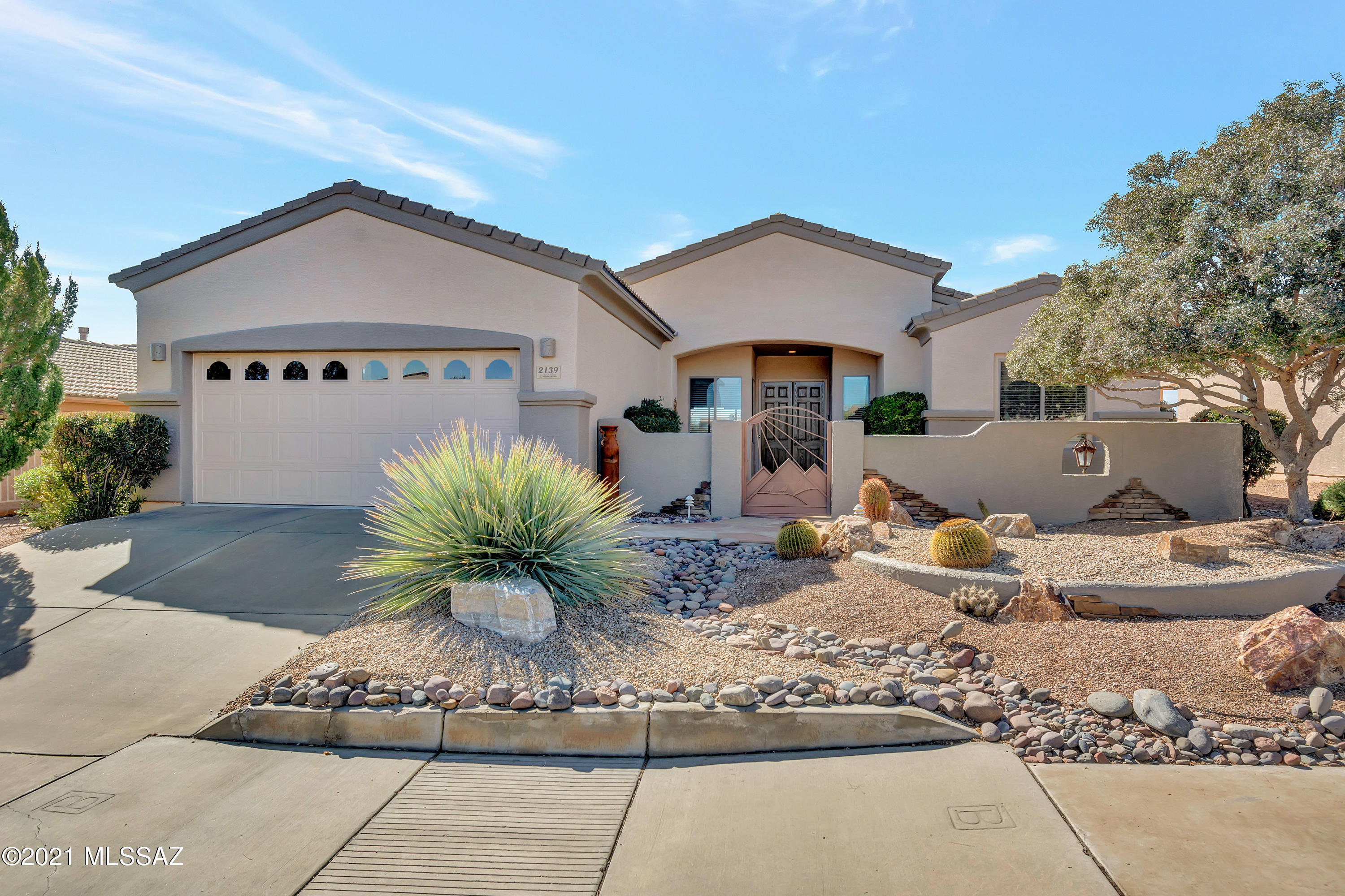Outstanding views are yours from this well-maintained home located ''high on a ridge'' in the Gated Canoa Northwest Community.  This open floor plan includes a great room with a gas fireplace, kitchen with granite counter tops, counter-bar & dining area and maple cabinets with under cabinet lights. There is tile floors in all the high traffic areas, a bay window in the dining and master bedroom and a beautiful trey ceiling in the additional dining or office area. The laundry room is off the kitchen with additional flex space. Easy care front & rear landscaping is on a drip system. Entertain on the back patio to the sounds of the waterfall as you enjoy the breathtaking views of the Santa Rita Mountains and Canoa Ranch Golf Course. Make this lovely home yours!