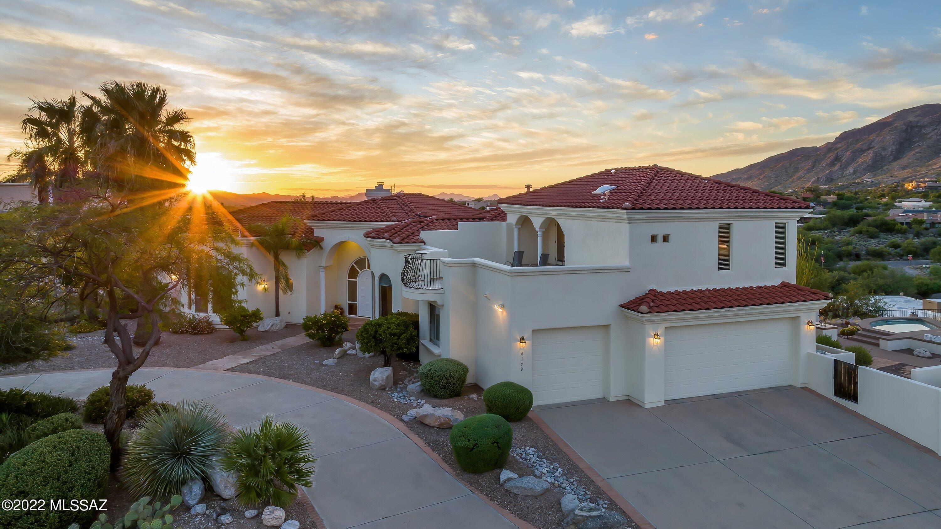 A remarkable find! Perched on a ridge top in a gated enclave of 13 homes with postcard-perfect views. We. Are. Not. Exaggerating...views in every direction; mountain, sunrise, sunset, desert, city lights, floor-to-ceiling, rooftop deck, you name it. Enjoy the best of Tucson outdoor living, and al-fresco dining under the expansive wrap-around covered patio that includes a built-in bar, BBQ, and sparkling spa. Inside offers an open and airy layout that has been meticulously maintained. Soaring ceilings, travertine flooring, and an abundance of natural light. The gourmet, eat-in kitchen is perfect for your inner chef. Separate living upstairs for friends and family to stay. This home is an entertainers delight! Minutes from grocers, dining, hiking, biking, golf, and more...