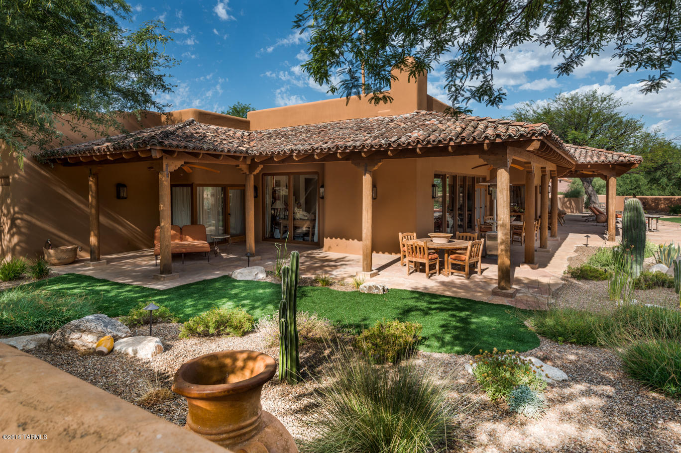 This is such an interesting property ---where to start! Outstanding horse property with 16 stalls & corrals for grazing and training on totally fenced 6.6 acres. The artisan well provides more than ample water for the most magnificent desert plantings of cactus, trees & flowers that are indigenous to this area. A peaceful setting with the melodious sound of birds singing and captivating views of mountains is the perfect setting for the quality Santa Fe home with covered beamed ceilings and wrap around patio -- summer and winter, this outdoor living is what Tucson is all about. A must see to fully appreciate the beauty!
What does not convey with the property is as follows: small fountain outside by master bed, portable round pen, 4 Tie post
