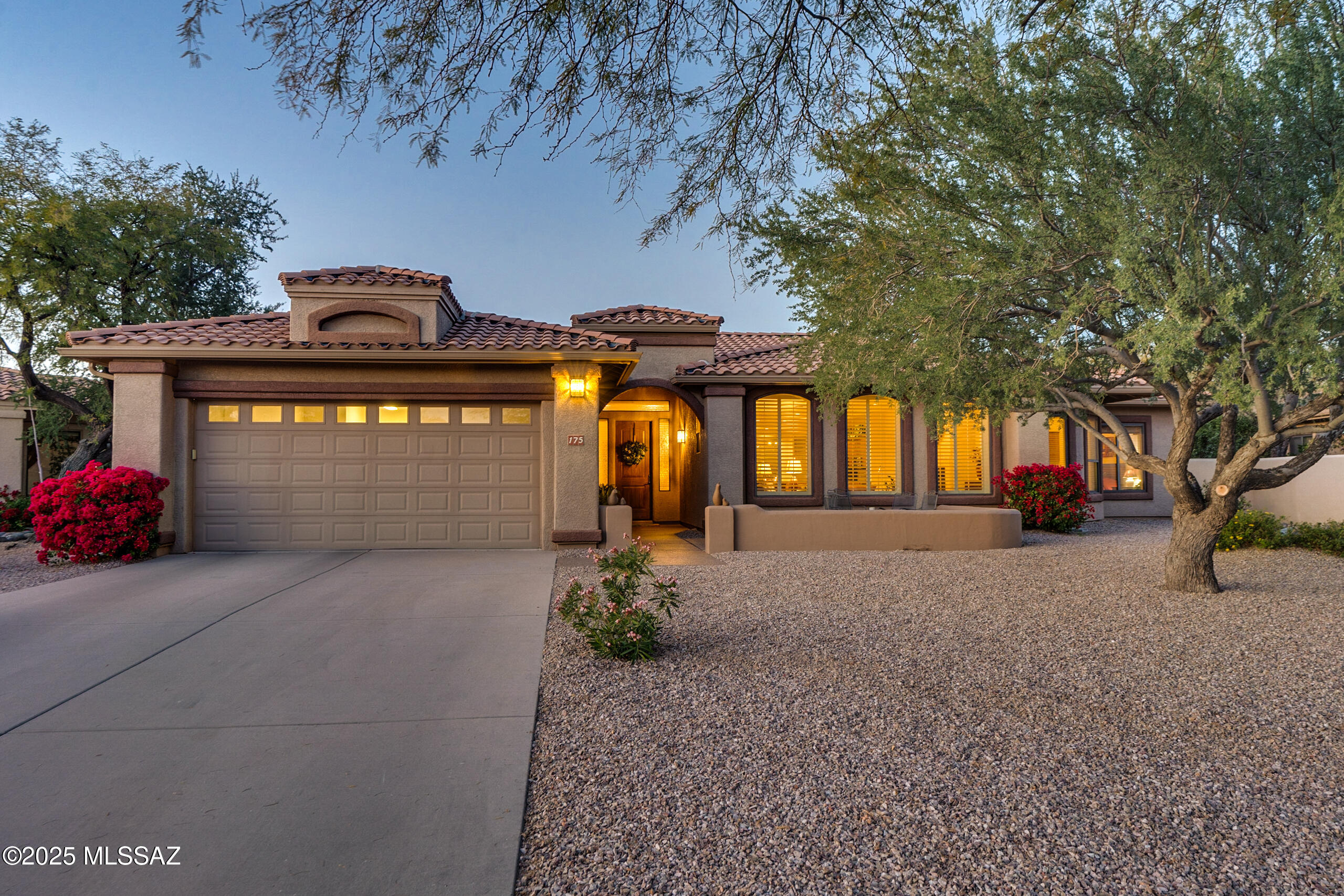 Nestled in the heart of Oro Valley, this elegant 3 bedroom, 2.5 bathroom + den/office home offers the perfect combination of comfort, style, & breathtaking natural beauty. Located within a secure gated community, this property provides privacy & peace of mind, all while being close to amenities & outdoor activities. This open great room floor plan with formal dining room offers ample natural light, ideal for entertaining or relaxing with loved ones. Updated eat-in kitchen with newer cabinets, granite countertops, gas cooktop, double ovens, stainless steel appliances & breakfast bar. The primary suite is a serene retreat with 2 walk-in closets, en-suite bath, dual vanities, walk-in shower & soaking tub. Two guest bedrooms with Jack & Jill bathroom offers  flexibility for family or guests. Beautifully landscaped backyard with enclosed patio, flagstone walkway, beehive fireplace & putting green. From the front courtyard you can enjoy amazing views of the majestic Pusch Ridge & Catalina Mountains. All located on a .33 acre cul-de-sac lot in the gated community of Sunstone Estates offering a community pool & spa!