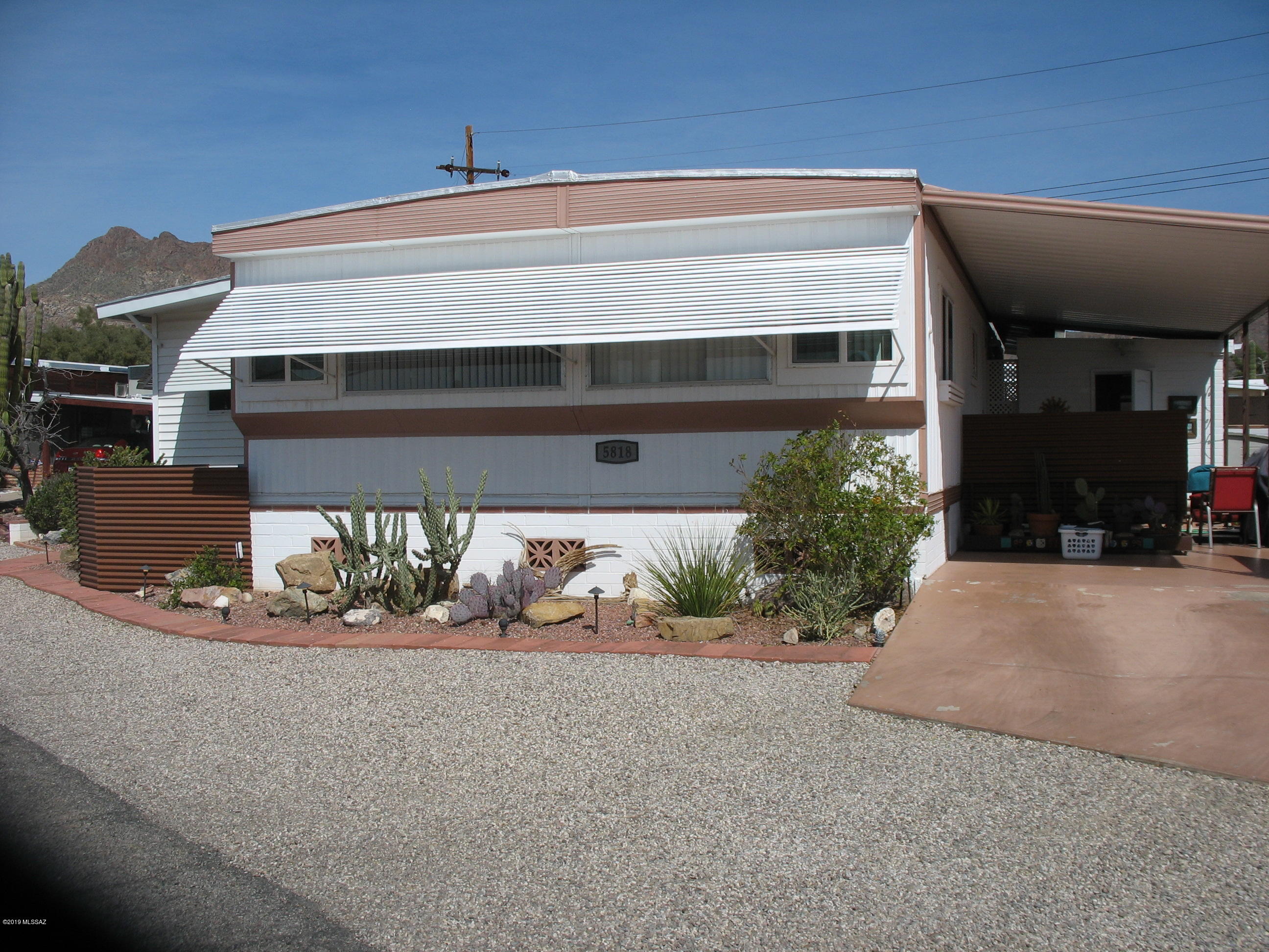 If you have been looking for a totally updated and renovated home, look no further, this is the one!  Windows and doors have been replaced.  New flooring.  plumbing, gas line, 3 yr old gas pak furnace AC unit.  Walls have been taped/textured.  Open kitchen to living room.  Private backyard patio.  Whole house water softener.  Includes 8 x 30 AZ room that is open to the living room.  Separate 10 x 27 building with half bath contains laundry and can be used as a studio.  This TE Community is adjacent to 44,400 acres of Parkland (Tucson Mountain Park/Saguaro National Park West) with more than 68 miles of hiking, biking & equestrian trails.  The HOA fee includes unlimited golf, tennis, pickle ball, shuffleboard, 3 pools, spa, exercise room, trash collection, and a lot more.  You own the lan
