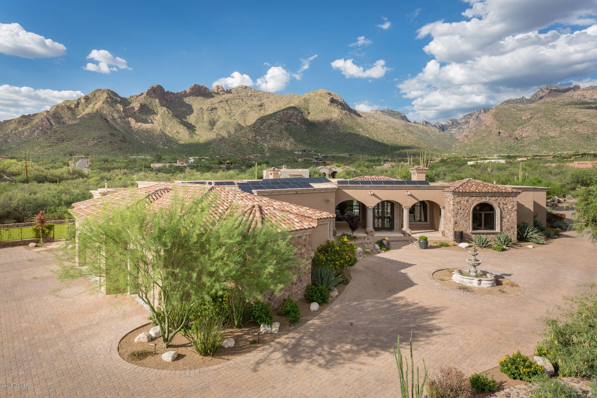 Masterful design & luxury are embodied in this distinctive 7150sqft, 4 BR, 7 BA, 2.66ac villa. This one of a kind home, created by Christian Dixon, is nestled deep in the foothills w/stunning city & unobstructed mountain views.  Every detail carefully selected & quality crafted. A divine master suite presents massive windows, fireplace, opulent en suite bath & exercise room.  Automatic sliding doors in the living & dining area showcase awe inspiring views while opening the home to even more light & air. Other highlights include natural stone floors, cantera accents, whole home automation, high tech security system, whole home water filtration, fully appointed media & rec rooms, study w/en suite & Murphy bed, top of the line chef's kitchen, pool & spa w/water features & the list goes on...