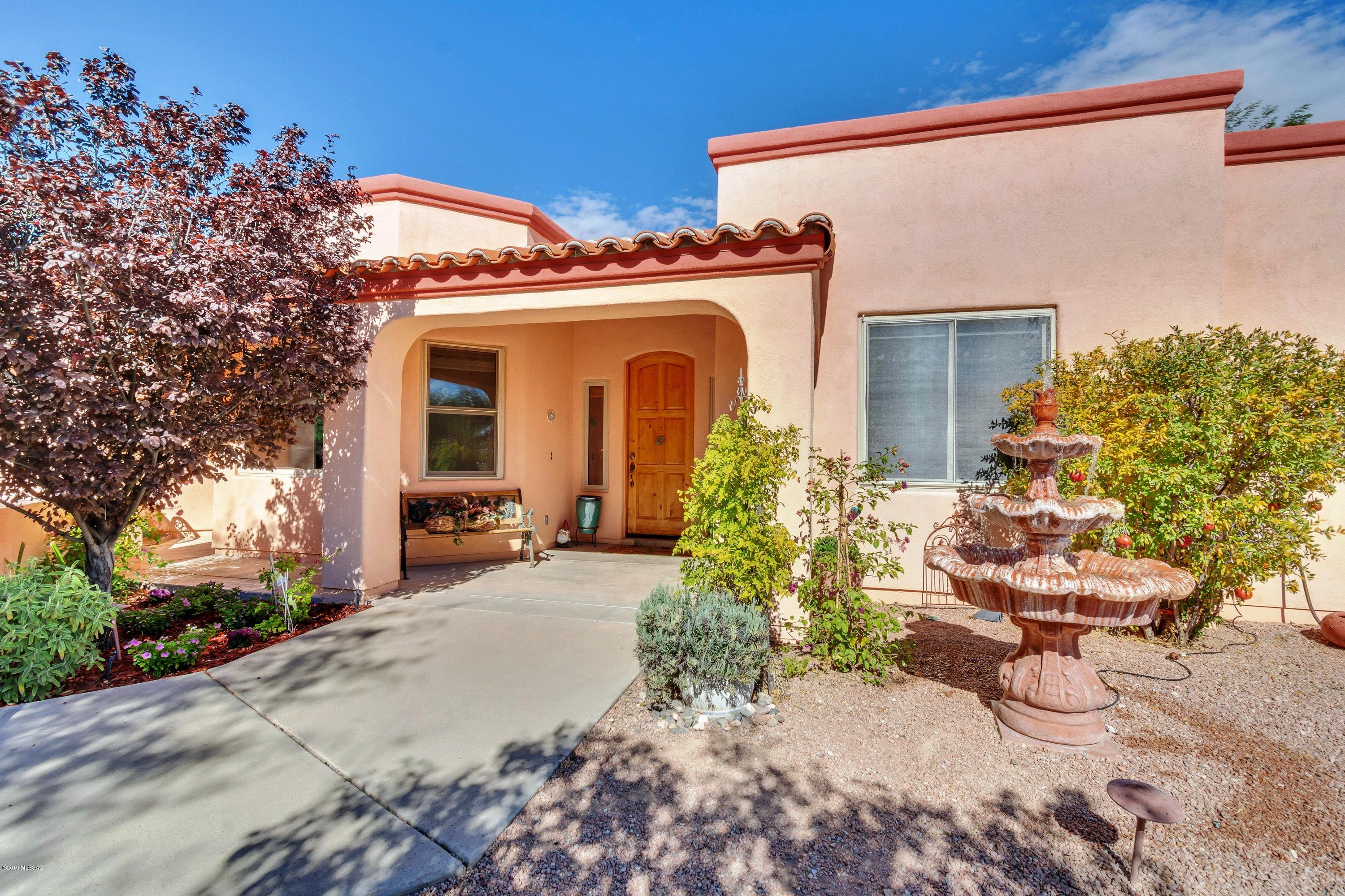 One of the few custom homes in Sabino Creek - soft Mediterranean with lush resort-style back yard. Beautiful living area with soaring 18 ft cathedral ceiling, formal dining rm with built in display cabinets, cook's kitchen with generous island. Private wheelchair accessible master suite has charming sitting area and features a  roll-in shower in the en-suite bath. 3 more ample bedrooms, all with walk-in closets plus a versatile flex rm adjacent to the master (for office, den etc). Back yard is spectacular with deep north-facing patio, gorgeous mature landscaping, secluded pebble-tec pool w/waterfall, free-standing hot tub. Keyhole views provide a peek at the Catalina and Rincon mountains. All perfectly maintained on private .43 acre lot.