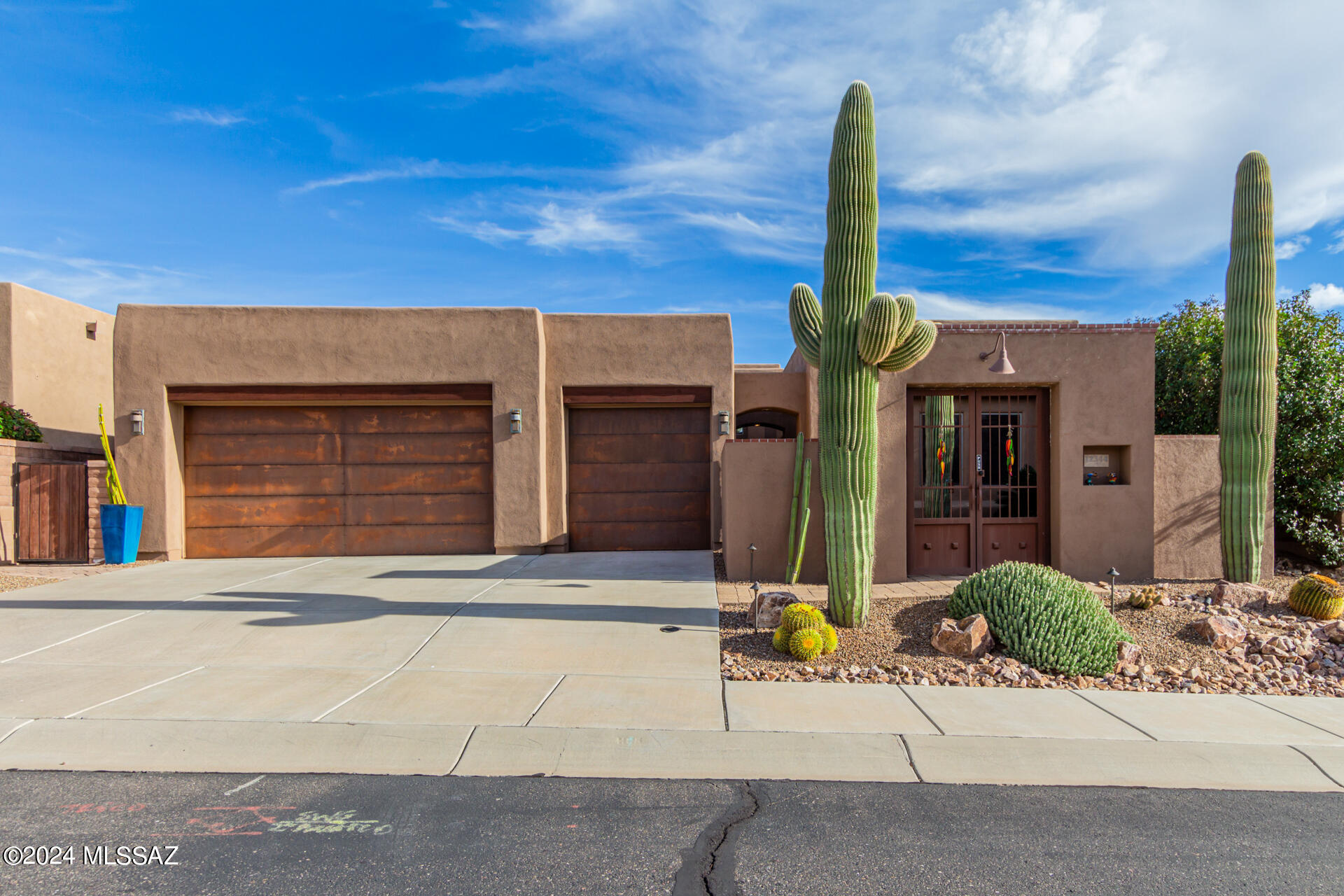 You have found your next home! Insight Homes customized Agave floorplan is dialed in & ready for you! This sanctuary features 2349 s ft of beautiful Sonoran Desert Living w/10 and 12' ceilings & 8' knotty alder doors throughout. Home features primary & guest ensuite bdrms, + den & powder room.  GREAT ROOM plan w/rocked gas fireplace & customized wet bar w/matching ledgestone, cabinetry & wine cooler!! Nicely appointed gourmet kitchen boasts staggered raised panel knotty alder cabinetry w/heavy duty rollouts, quartz countertops, tile backsplash, GE SS appliances, incl raised dishwasher. 1 of a kind fr. courtyard w/new gates private inner space & sliding glass door to kitchen. Resort-like back patio w/solar heated pool/spa, extended covered area and STUNNING CATALINA MTN & PRESERVE views!!! This stunning home greets you with MASSIVE saguaros and cacti landscaping and amazing back yard to relax in.  Home was professionally re-painted in 2020 and roof professionally re-coated 02/2023. Tucson Rolling Shutters on primary suite windows for privacy & security, plus locking screen door at patio & entry door/ courtyard patio door w/motorized rolling sunscreen. Entire home has upgraded electrical, lighting, painting, & Hunter Douglas window treatments. Kitchen currently has GE Profile Side by Side Stainless Refrigerator, new 10-2023, newer GE Cafe Induction cooktop, but also plumbed for gas (if you prefer) along with GE wall oven, microwave and raised dishwasher.  Maytag Maxima washer & dryer in laundry room with matching cabinetry, laundry sink, opening window and pet door. Spacious 3-car garage with rustic steel panel doors, closet system w/16 & 20" deep units, adjustable shelving & mounted 6" off floor to keep floor clean ~ there is also a golf bag cabinet that holds 2 sets of clubs. Additionally, garage boasts service door to side yard and 2nd one to private inner courtyard, water softener, NEW RO system to drinking tap & refrigerator10/2023.  Garage also has newer 50-gal water heater, 6/2022, work bench and slat board with hooks for tools.  Extended back covered patio is equipped with misters, chili pepper rope lighting, custom sconces, TV mount and pre-plumbed for gas BBQ. Beautiful freshwater pool/spa and water feature, solar heated, owner owned. This home will not disappoint ~ it is truly a GEM!!!