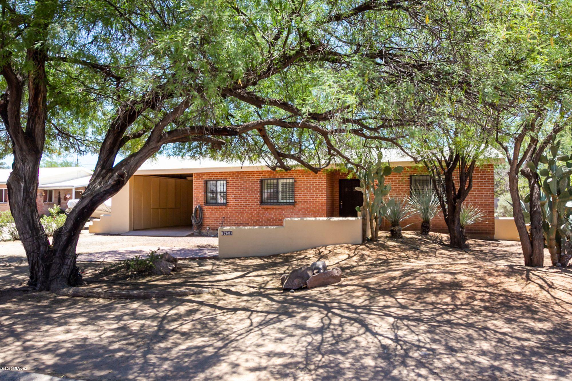 Split 3BD/2BA designed double brick home, open and airy living room with brick fireplace. Double Glass doors lead to enclosed rear patio and huge back yard. Perfect for RV/boat storage or pool. Bright kitchen with lots of counter/cabinet space. Separate pantry/utility room with veggie-sink and dishwasher. Master bedroom has vaulted ceilings, walk-in closet w/built-ins. Single carport also offers cabinet storage. Freshly painted inside and out. Plantation shutters on all windows. Large laundry room. NO HOA! A/C and Hot Water Tank replaced in 2017. Motivated seller! Close to everything, malls, shopping and restaurants. Plus 2-10 home warranty. Professional pictures soon