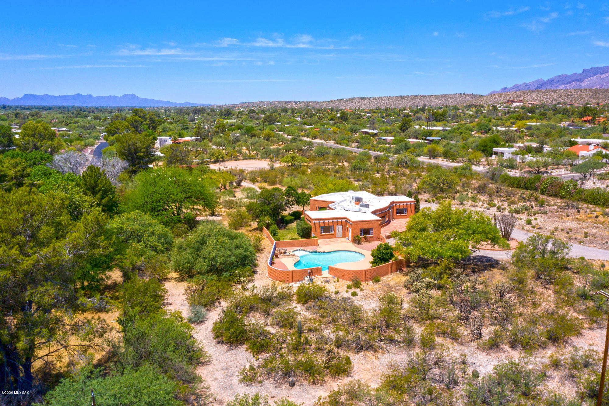 Peaceful, Quiet, Private 3BR Santa Fe charmer with a 1BR Guest House, Pool, Horse Facilities, and a Private Well, located on a close in 4.0 Acre Lot. Also panoramic unobstructable Mountain Views - a Very Rare Find! Large front mountain/sunset view Patio, spacious Living Room with high beamed ceilings, fireplace and those mountain views! Split Master Suite, Formal Dining Room, Large Family Room with fireplace, those views, and a walk In closet - could be another BR - separate entrance, too. Kitchen opens to the Laundry Room.  Huge waterfall pool, grassy play yard, too. Stroll down the path, past the entertainment patio with fireplace, and past the private domestic well, to the 1BR/1BA Guest House with a covered Patio and a huge storage room behind. Continue to horse stables/corrals. 
  WOW