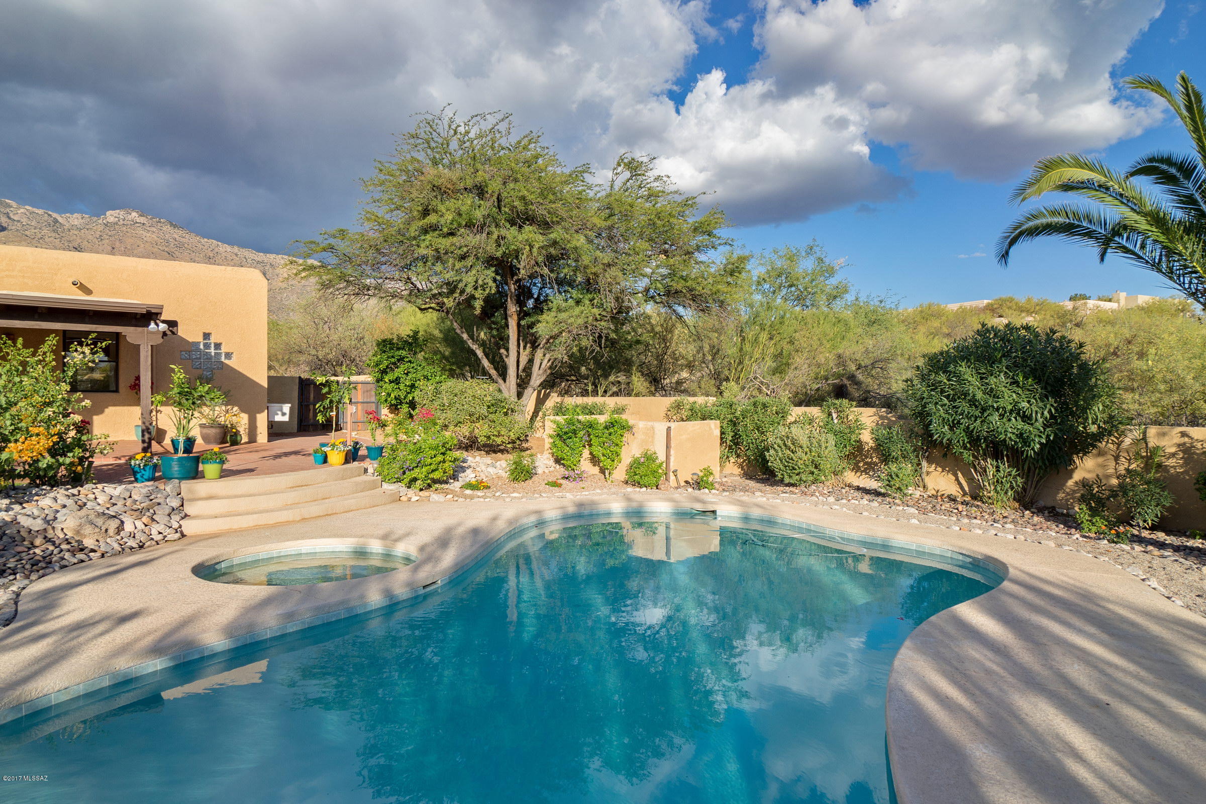 Private corner lot, ready to move right in! Just start planning your get togethers - use that chef's kitchen with gas range and double ovens, then relax on the covered patio, overlooking the lush private yard and pool area.   The mountain views are gorgeous too!  5 bedrooms (including dual master suites), 3 add'l, 4 baths total, 3450 sq ft.  You'll love it!  Freshly painted inside and out, roof recoated, pool resurfaced and even new carpet.
