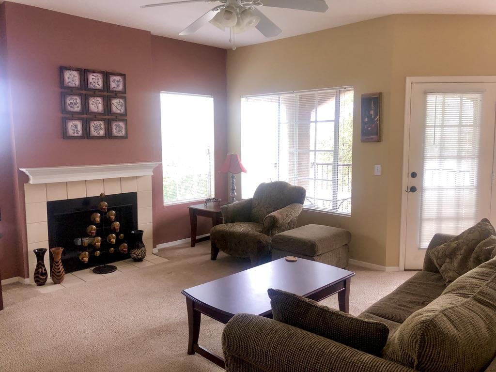 Come home to the prestigious community of The Boulders at La Reserve. Fully furnished, this second-level unit (#9208) features a wood-burning fireplace in the living room; beautiful natural light with views of the mountains and nearby trees; newer washer and dryer; water heater is about a year old; AC unit and condenser installed 4 years ago. It is just steps away from the resort-style Club House with year-round heated pool and spa; a fitness rooms with weights and cardio; nice kitchen; lounge area with TV; picnic and BBQ area.  Relax on your private, covered balcony and enjoy the view of Catalina Mountains.  Shopping and restaurants, golfing and hiking/bike trail nearby. This unit has an assigned carport location.