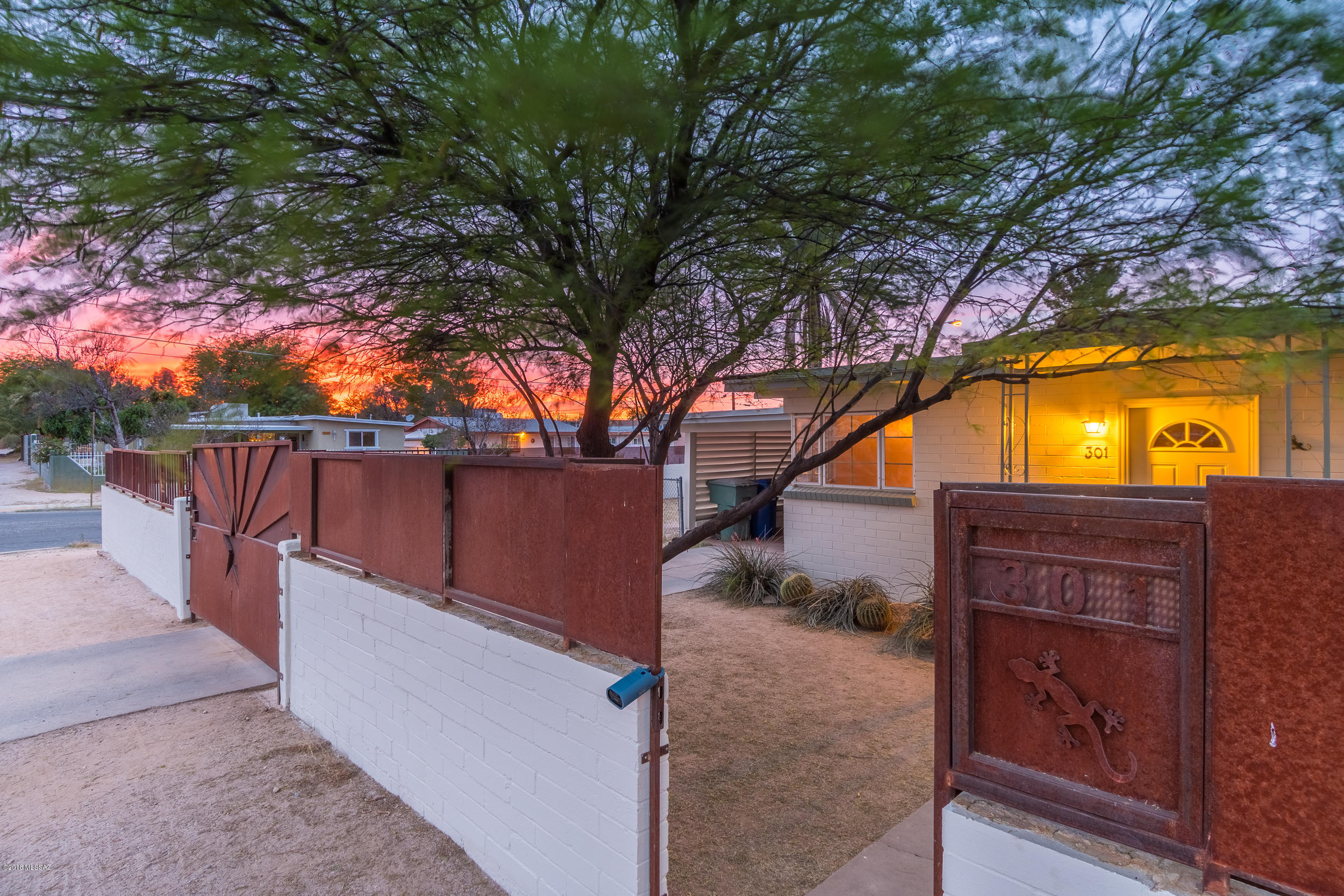 Don't miss out on this adorable, central bungalow. Charm and character throughout this hidden gem. Exposed wood beam ceilings create a subtle warmth. Over sized lot with a block wall and rusted steel create a private setting with a detached studio for an extra creative space. Newly painted inside and out. New A/C installed in 2016. Also recent roof re-coating with warranty makes this the perfect home for first time buyers. Don't wait. Bring offers!!!