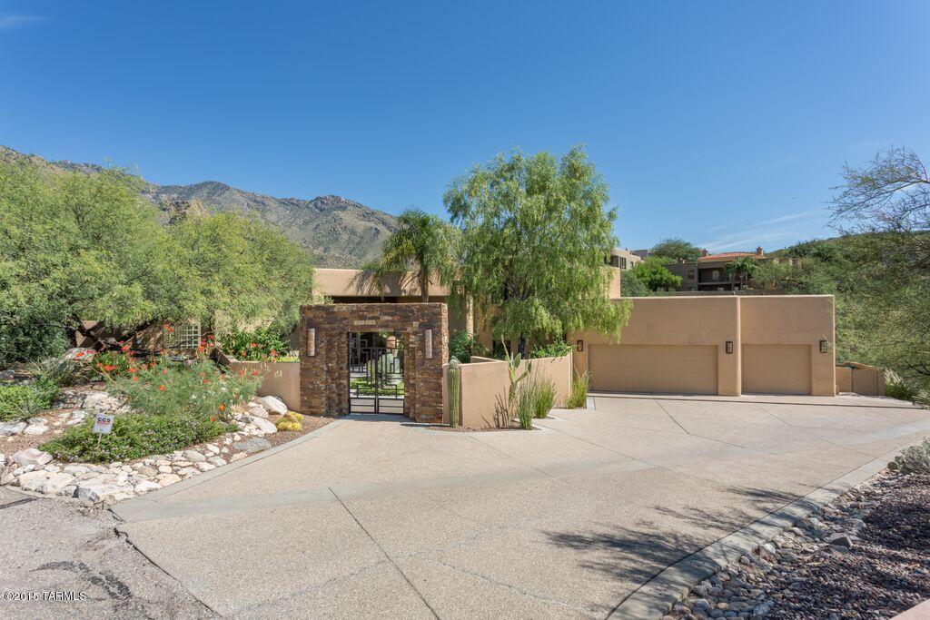 VIEWS, VIEWS, VIEWS! Enjoy the panoramic mountain views while sitting at your outdoor fireplace and listening to the waterfall by the Award winning pool and lagoon with LED lighting and many color alternatives! Or come inside to your gourmet kitchen which boasts of cherry wood cabinets, granite countertops, large wine fridge, wolf range, custom metal hood, and so much more! Custom chandeliers in both the formal dining room and the breakfast nook. Oversized master with luxury bath, large walk in closet, and fireplace. 2nd room also on 1st floor perfect for an office or guest room. Bedrooms upstairs have designer custom wall paper and built in desk nook. The concrete floors downstairs and wood flooring upstairs makes this modern, contemporary home come to life.