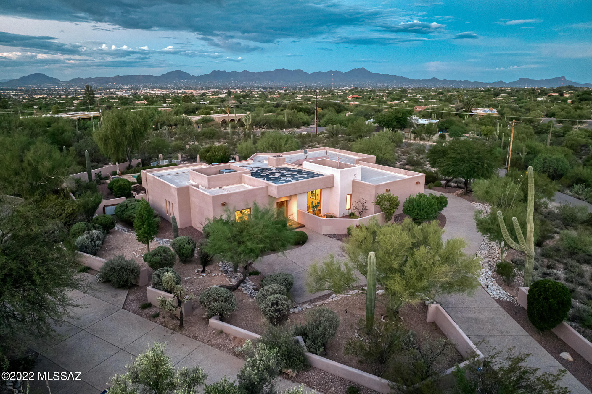Beautiful southwestern contemporary, designed and built by renowned architect & builder David Tyson. With 3,237 Sq Ft and 5 bedrooms & 4 bathrooms, the single level, split floor plan offers generous space yet private comfort & luxury. Sitting clandestinely on nearly 1 ½ acres in Catalina Foothills, the panoramic Catalina Mountain views are prominently featured with Finger Rock framed immaculately from the dining room. Resplendent chocolate Saltillo tile floors are featured throughout the common spaces and spacious primary bedroom. The backyard is surrounded by serene desert landscape &  features resort-style amenities that provide perfect relaxation & entertainment options: solar heated pool & waterfall, hot tub, outdoor kitchen, gas fire table & dining space under the large covered patio The primary suite is positioned with direct access to the backyard and is its own large retreat with over 300 Sq Ft of space and a spa-like ensuite primary bathroom and large walk-in closet. Just off the living room, is a guest bedroom that could be utilized as natural light filled office space with an adjacent full bathroom. Three additional guest bedrooms sit on the opposite side of the home, creating a secluded guest wing with an ensuite bedroom and additional hall bathroom.
 
The kitchen and family room are well thought out for both entertainment and intimate family gatherings. Sub-Zero refrigerator, Asko dishwasher and high-end appliances complement the cook's kitchen. Tyson character and details are seen throughout, including the open concept pantry. The family room is a flex space with a myriad of options ranging from homework or playroom, music room, reading or craft space, bar or media room or the traditional family room.
 
The home is in a non-HOA community (Voluntary) with phenomenal location with District 16 schools, close proximity to La Encantada and Joesler Village, La Paloma Country Club and direct access to downtown. Countless details and Tyson character throughout with a high level of maintenance in this one owner home. 3-car garage with additional storage and flat driveway with guest parking spaces.