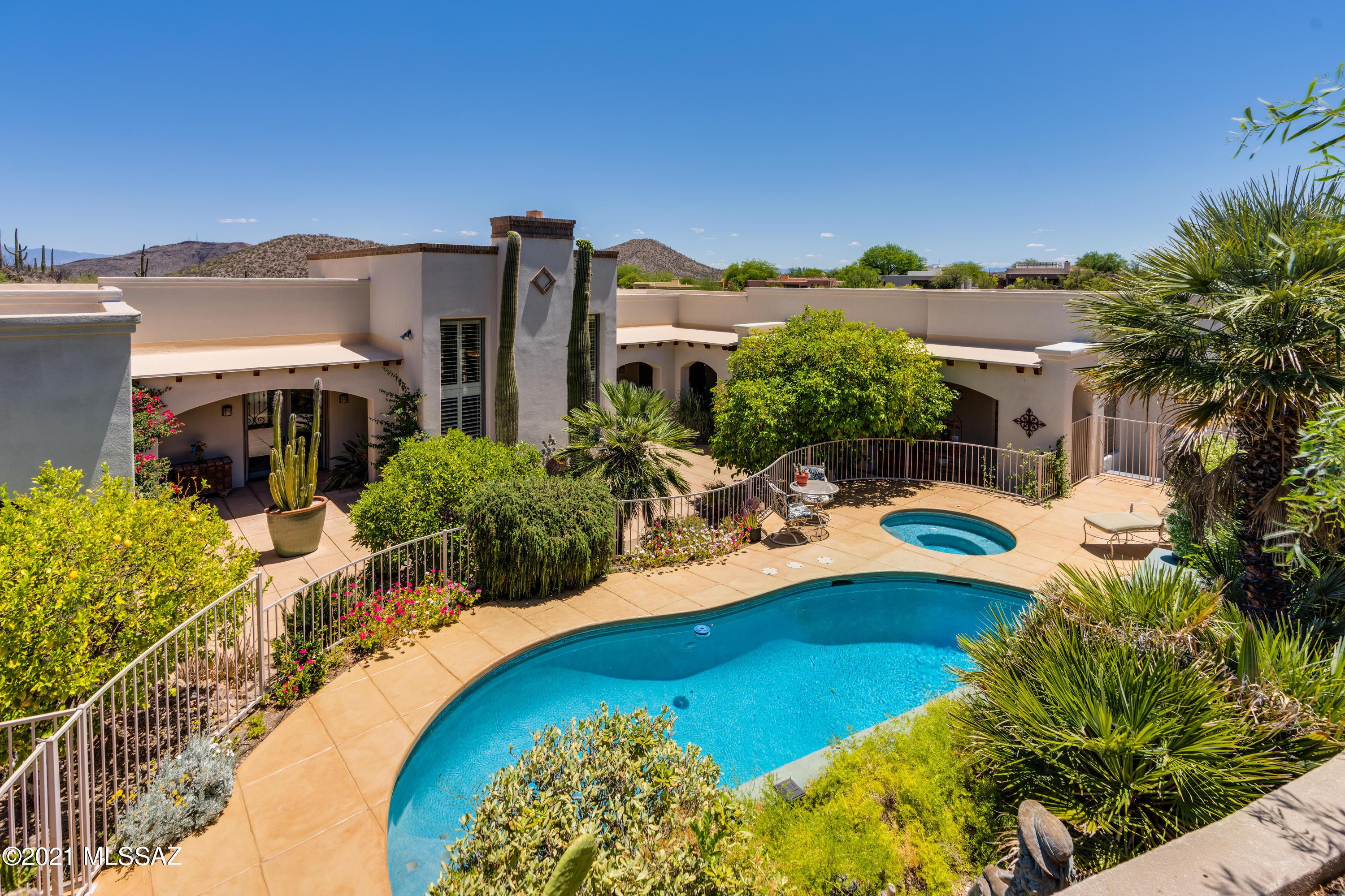 One-of-a-kind custom concrete block home by Alexandra Hayes, built into the hillside minutes away from Starr Pass Resort. Located on a cul-de-sac, this beautiful home offers privacy and amazing desert views. The spacious living area features high, wood beamed ceilings, a beautiful gas fireplace and formal dining room with its own balcony to enjoy desert evenings. The large kitchen has new double ovens, a 6-burner gas stove top, and an island. The kitchen is complemented by a huge walk-in pantry and butler's pantry with a sink and mini-fridge. Backyard is an entertainer's dream with a built-in BBQ, wood burning fireplace and mature vegetation including a variety of citrus trees.