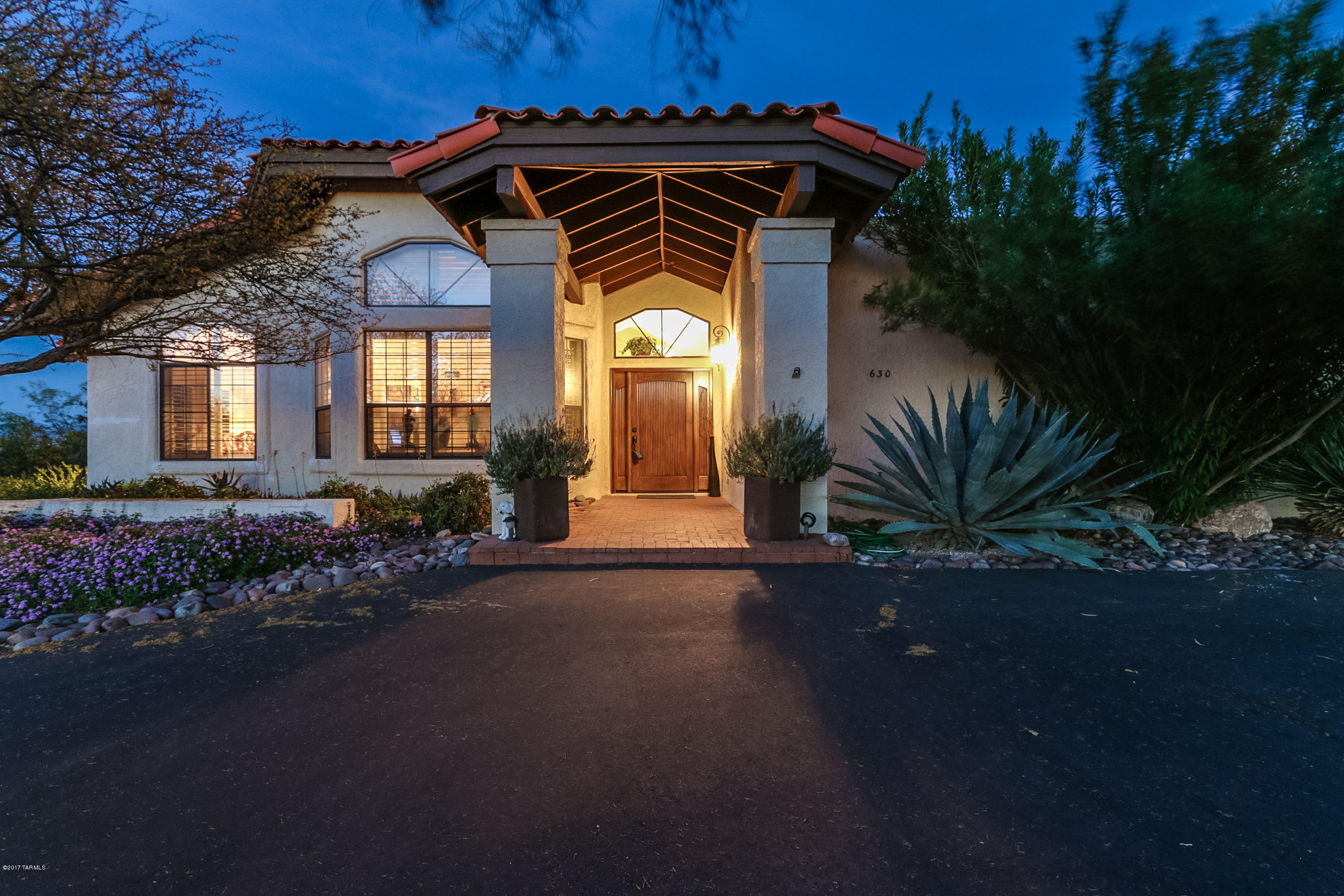 VIEWS, VIEWS, VIEWS in this nicely maintained house that sits high on a 1 acre lot. These panoramic views of the Catalina and Rincon Mountains are enhanced by the huge terraced brick patios that overlook the pool and spa. With a gorgeous new front door and paved circle driveway to greet you, this home boasts a large master suite with an additional 3 bedrooms. The Kitchen has granite counter tops and stainless steel appliances. Also included is an attached 2 car garage plus a 2 car detached garage with workshop, Mastercool and water. Both with epoxy floors. The roof is newly coated and all outside wood newly painted.