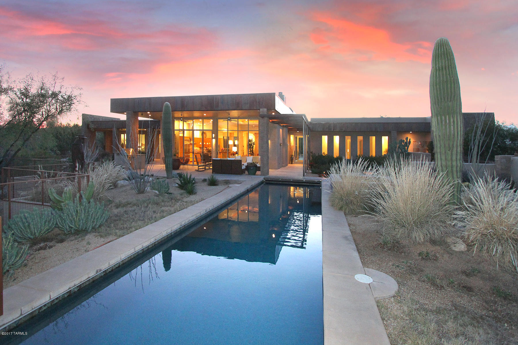 Exquisite estate perched on a 3 acre lot in Coyote Creek bordering State land and offering great Rincon Mountains views! Long winding driveway leads to this one of a kind home. Unique rustic metal facing and split faced block construction. Spacious open floor plan with soaring ceilings and walls of windows capturing incredible views. Dream kitchen has beautiful rift cut white oak cabinetry, granite counters and top of the line appliances. Private master suite with hardwood floors. custom tile, luxurious bathrooms, stained colored concrete floors and more! Resort backyard has 50' lap pool, spa, privacy and views. Please view full size interactive floor plan in the virtual tour link in photo tab.

You will find the Special Feature List and Tucson Lifestyle Article about the landscaping design in the document link.

View videos here:
https://drive.google.com/file/d/0B1VsIRuN1-gEb19xMVloOWVqUlE/view

https://drive.google.com/file/d/0B1VsIRuN1-gEQTJsYkxpdmI1RkE/view

The landscaping was designed by 2 or 3 time Gold Medal award winner Paul Connelly and was featured in the Tucson Lifestyle magazine. There are three 1700 gallon underground rainwater storage tanks for the irrigation system. The landscaping seamlessly melds the back porch into the natural desert beyond.

Please note the home currently is situated on 2 lots (lots 157 & 158) that were combined by Sellers. The home (on lot 158) is offered for sale on lot 158 only. Buyers of the home will have first option to purchase lot 157 for $145,000. Call LA for more info.

Please read the 6 page Special Feature List in the attached documents. It shows that it could cost approx. $2,000,000 to reproduce this amazing property (actual and estimated replacement costs).