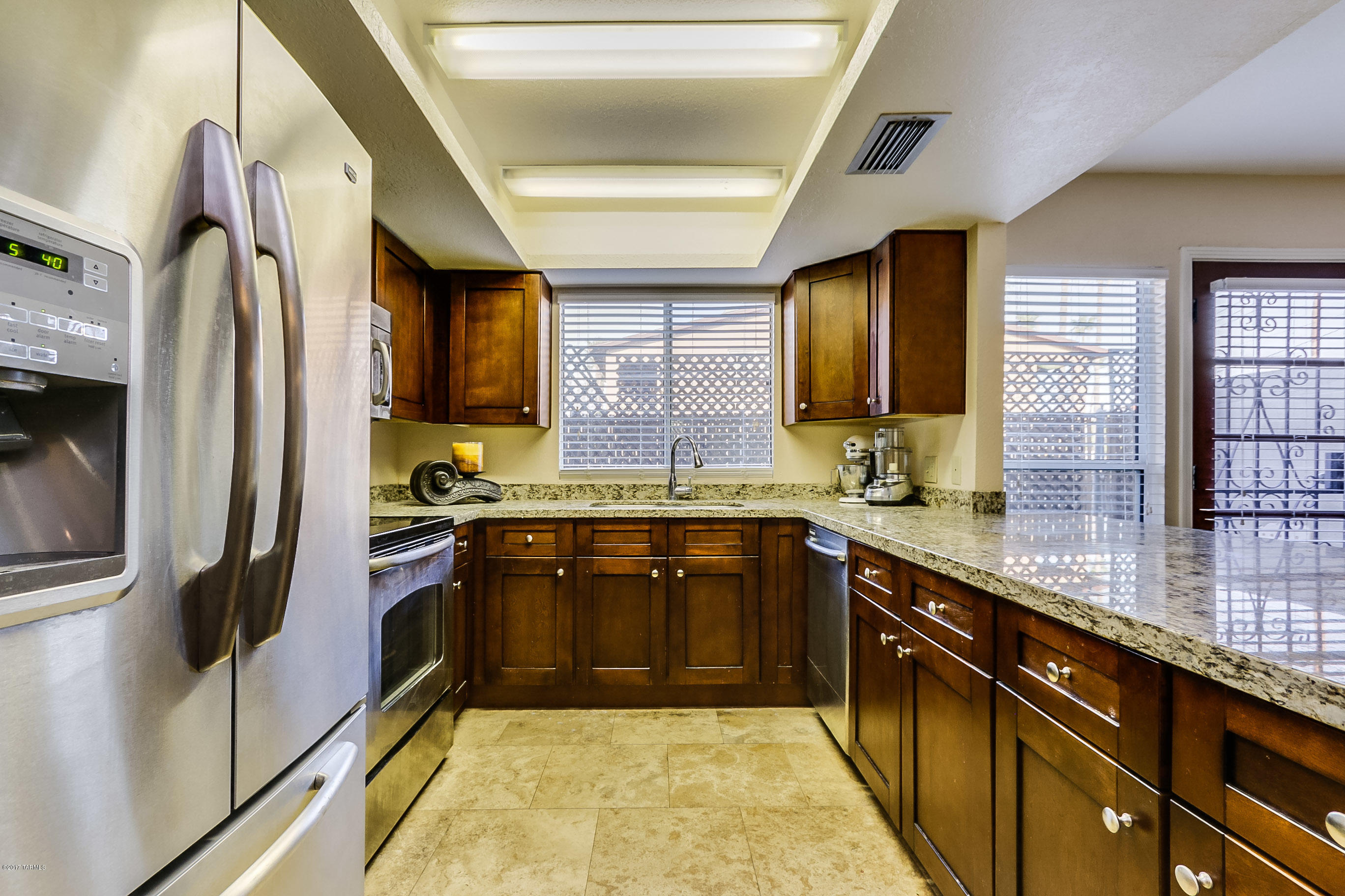 Beautiful Updated 3 BR/3BA Townhome.  Fantastic Central Location close to UofA, UMC, Mountain Bike Path, Riverwalk, Downtown, shopping and restaurants.  Updates include newer kitchen cabinets, solid granite countertops, SS appliances, all baths have been upgraded, travertine flooring and newer carpeting.  Large bedrooms and great storage space inside and out.  All appliances stay.  Community pool, tot lot, and basketball/sport court.  This one is a Must See.