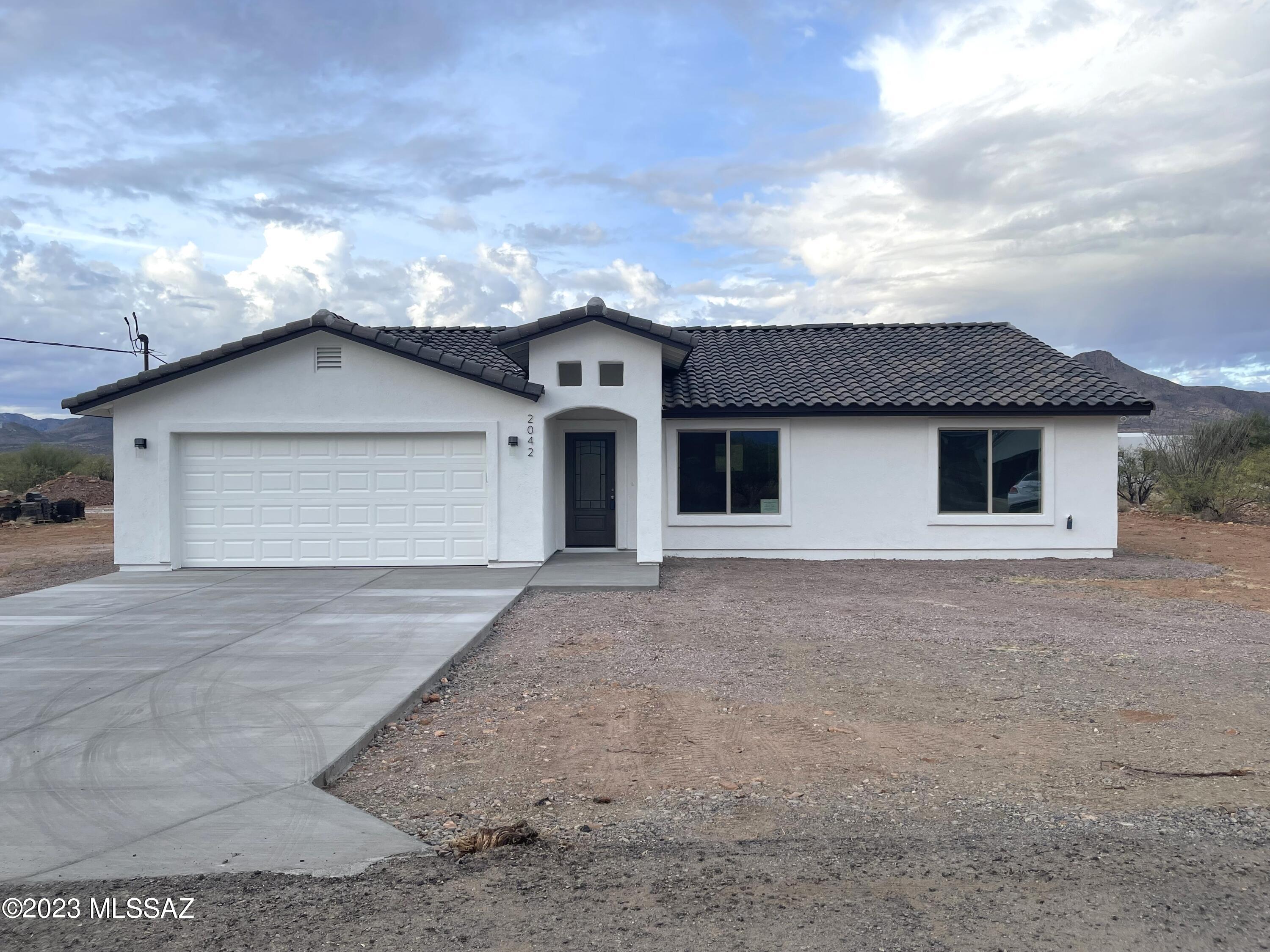 VIEWS, VIEWS, and VIEWS! New Construction-MOVE-IN READY!    This beautiful 3 bedroom, 2 bath home has an open floor plan filled with natural lighting throughout. Just off the kitchen, the open area of the living room & dining room provides plenty of space for the entire family to spread out comfortably. The home faces east/west with exceptional views of the surrounding mountains. The kitchen includes custom cabinetry, granite countertops, an island, & SS appliances. Fine upgrades can be appreciated throughout the home such as spacious bedrooms,  an oversized walk-in closet in the MB, tile floors throughout, ceramic tile in shower wall surroundings, vaulted ceilings, upgraded light, & plumbing fixtures.  Come and enjoy the great living Rio Rico has to offer. Rio Rico offers an abundance of recreational opportunities such as hiking, birdwatching, and it's nature.    This beautiful home is minutes away from the interstate for easy traveling to Nogales/Rio Rico or Tucson.
