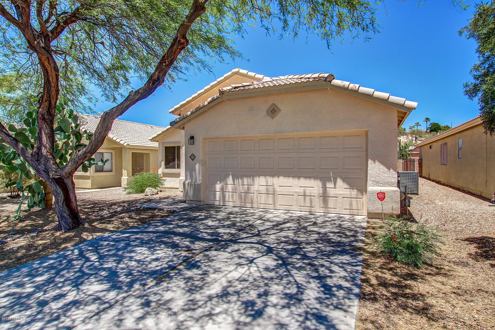 Home sweet home! Charming 3 bed 2 bath home in a great Tucson location! Cross the threshold and fall in love with the vaulted ceilings, tile flooring, and custom designer paint throughout. Eat in kitchen opens to the family room and offers a plethora of cabinets, ample counter space, and center island. Each spacious bedroom has picture windows. Master includes an adjoining bath. Serene backyard is complete with a covered patio and colorful desert landscape. Discover this hidden gem today before it's gone! 2-10 HOME WARRANTY WITH AC COVERAGE INCLUDED WITH PURCHASE.