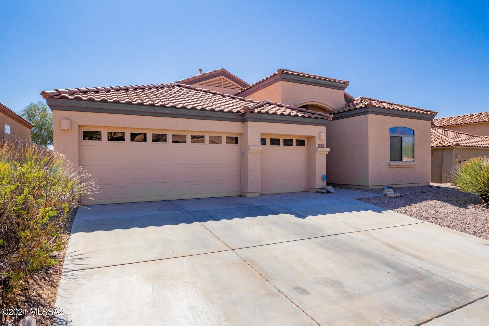 Minutes from Del Lago Golf Club, this spacious, move-in ready and refreshed 4 bed 2 bath home gives you all the elbow room you need inside while enhancing your outdoor living with a salt water pool and an extended paver seating area.   Upon entering the home you'll notice the new luxury vinyl plank flooring through the entry way into the great room and kitchen.   Picture yourself entertaining friends and family here for the holidays! The great room allows for a dining area (the adult table)  and a big tv/seating area with a door leading out to the back patio.   The kitchen is roomy enough for a family sized table and features granite countertops, new stainless appliances, and a breakfast bar.  Adjacent to the kitchen is a den that's great as an at-home work space, tv room, or play space for the littles. The guest rooms in the split floorplan share the 2nd bath and all with new carpeting.  A roomy owner's suite provides a respite from the common area through a foyer entry and  features access to the patio.  Escape the inside commotion and watch the night skies for a minute of calm. The  en-suite bathroom features a soaking tub, separate shower and executive height dual vanities.   The gated neighborhood offers a safe and friendly living environment, minutes away highly rated Vail schools.