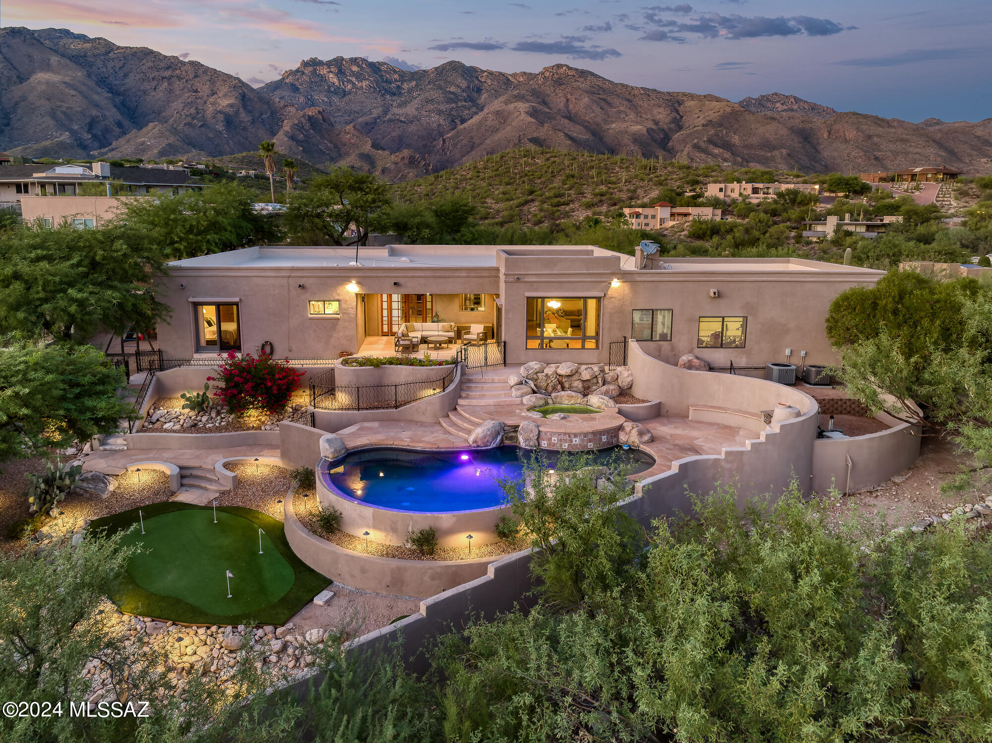 With over an acre lot nestled in the sought-after Catalina Foothills, this stunning 4-bedroom, 2.5-bathroom home offers the perfect blend of desert tranquility and modern elegance. The property sits on an expansive 1.10 acre lot, providing breathtaking, unobstructed views of the Santa Catalina Mountains and the Tucson city lights. The residence boasts 3,559 Sq Ft of well-designed living space with an open floor plan that features wood beamed ceilings, oversized windows, and abundant natural light.

The gourmet kitchen is a chef's dream, featuring quartz countertops, alder cabinets, stainless steel appliances, and a large island perfect for entertaining. The adjoining family room opens to a spacious outdoor patio, ideal for al fresco dining while enjoying the beautiful Arizona sunsets. In addition to the family room, an expansive living room and sitting area combine to over 550 Sq Ft of phenomenal entertainment space or private family enjoyment. The breakfast area is accommodating as additional dining space or bar, playroom, or library.

The primary suite offers a private retreat with an updated luxurious en-suite bathroom, walk-in closet, and access to a secluded patio. Three additional bedrooms are generously sized, adjacent to the hall bathroom, creating a private family living quarter. 

A flex space, which could be used as a den, office or workout room provides various options for expanded living. The laundry room also offers generous space, which could also be utilized for storage and butler's pantry with additional refrigerator and wine cooler.

Outside, the backyard oasis includes a pool & spa, mature desert landscaping, putting green, built-in BBQ and multiple seating areas to enjoy the stunning desert scenery. The covered patio provides additional dining options with fantastic city views. A two-car garage and additional parking make this home as practical as it is beautiful.

Located in the highly acclaimed Catalina Foothills School District and just minutes from fine dining, shopping, and hiking trails, this home offers the best of Tucson living.

Living in Cimarron offers numerous benefits.

Breathtaking Mountain Views
Cimarron boasts stunning views of the Santa Catalina Mountains and downtown Tucson, offering some of the most spectacular sunsets and picturesque desert landscapes in the region.

Quiet and Peaceful Community
Cimarron is known for its quiet, low-traffic streets and large lots, providing a tranquil and serene atmosphere. The spacious, well-maintained homes offer plenty of privacy, perfect for those seeking a peaceful desert retreat.

Close to Nature
For outdoor enthusiasts, Cimarron is located near popular hiking and biking trails in Sabino Canyon and the Coronado National Forest. Residents can easily access nature for recreational activities like hiking, mountain biking, and bird watching.

Proximity to City Amenities
Despite its secluded feel, Cimarron is just a short drive from upscale shopping, dining, and entertainment options at La Encantada Mall and other popular spots in the Catalina Foothills area. You're also close to Tucson's vibrant downtown and the University of Arizona.

Top-Rated Schools
Cimarron falls within the boundaries of the Catalina Foothills School District, one of the highest-ranked school districts in Arizona, making it an excellent choice for families seeking quality education.

Luxury Homes and Spacious Lots
The neighborhood features beautiful custom-built homes, many with modern designs, luxury finishes, and private pools. The larger lot sizes offer plenty of space for outdoor living, with breathtaking views of the surrounding desert and mountains.

Mild Climate
Tucson's desert climate offers mild winters, making outdoor activities possible year-round. The elevation in Cimarron keeps summer temperatures a bit cooler than in other parts of Tucson, and the evenings tend to be comfortable, perfect for stargazing or relaxing outdoors.

Safe and Secure
Cimarron is known for its low crime rates, offering a safe environment for families, retirees, and anyone looking for a peaceful and secure place to live.

Cimarron offers the perfect mix of natural beauty, modern convenience, and luxurious desert living, making it one of Tucson's most coveted neighborhoods.