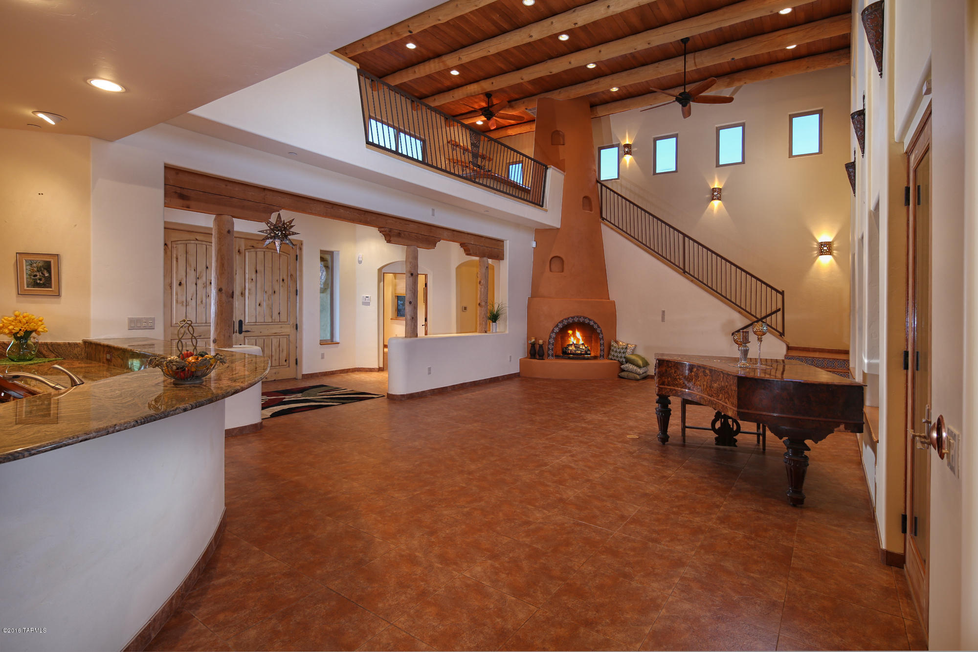 Enjoy the true lifestyle of private La Cholla Airpark for yourself...the thrill of takeoffs & landings, being surrounded by your own 8-acre desert landscape while living in a gorgeous 2009-built custom Santa Fe home that also has a 1784sf BASEMENT with both interior/exterior access, ready to be defined by you: extra living space, mancave... All this, and VIEWS!VIEWS!VIEWS! For airplane enthusiasts, there's also a 35'x42' HANGAR with living quarters, workbench and easy taxi to the 57AZ runway. 
In the home MAIN LEVEL LIVING offers 3 bdrms/3baths, formal dining, office, laundry and gourmet kitchen with prep island and breakfast bar open to spectacular great room with beamed 21' ceiling and 2-story fireplace.  Observation LOFT with wetbar has 360º views of Catalinas/Tortolitas/city lights!