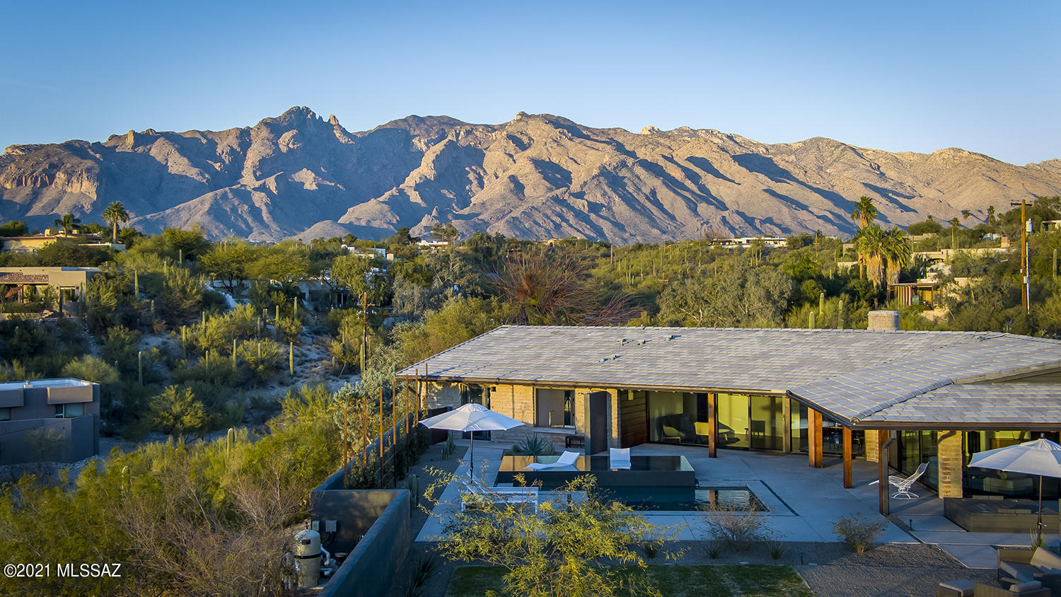 Stunning hilltop estate on over 3 acres with astonishing city and mountain views and a spectacular Saguaro grove. Gorgeous midcentury modern showpiece in prime Old Foothills location. Out of this world views and privacy yet close to U of A & Downtown. This property is in move-in, turnkey condition with modern finishes, services and amenities throughout. See upgrade list in documents for details. 

Main house features a breathtaking lofty open plan kitchen/living room/dining room/ den space with three spacious bedrooms and two and a half baths. Fireplace in living room is wood-burning.

Guest house features high ceilings, original pine floors, two BR's/ one Bath with ground-level basement incl two rooms plus laundry.