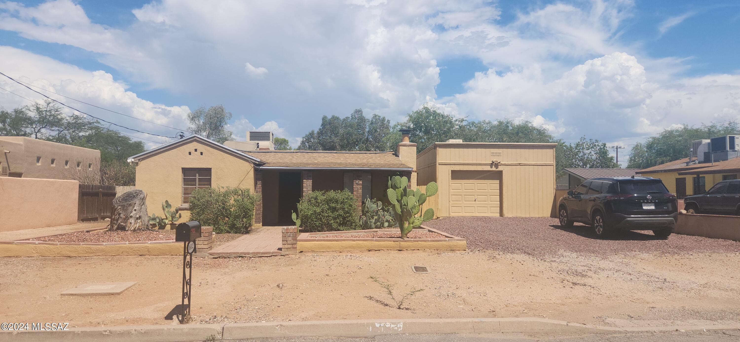 Charming 3 bed 2 bath bungalow in Central Tucson. Tile flooring throughout (no carpet!). Central AC. Cozy living room with fireplace. Master suite with master bath and private courtyard. 3rd bedroom is off the kitchen and could be used as a family room with a fireplace and glass slider to the back patio. Ceiling fans throughout. Covered porch at the front and covered patio at the back. Fully fenced Large backyard - perfect for entertaining with built in BBQ. Detached garage with space for workshop. Two storage sheds and double gate at side yard with room for boat or small RV. Non-smoking home. Minimum 1 year lease required. Renters insurance required. Call for leasing requirements.