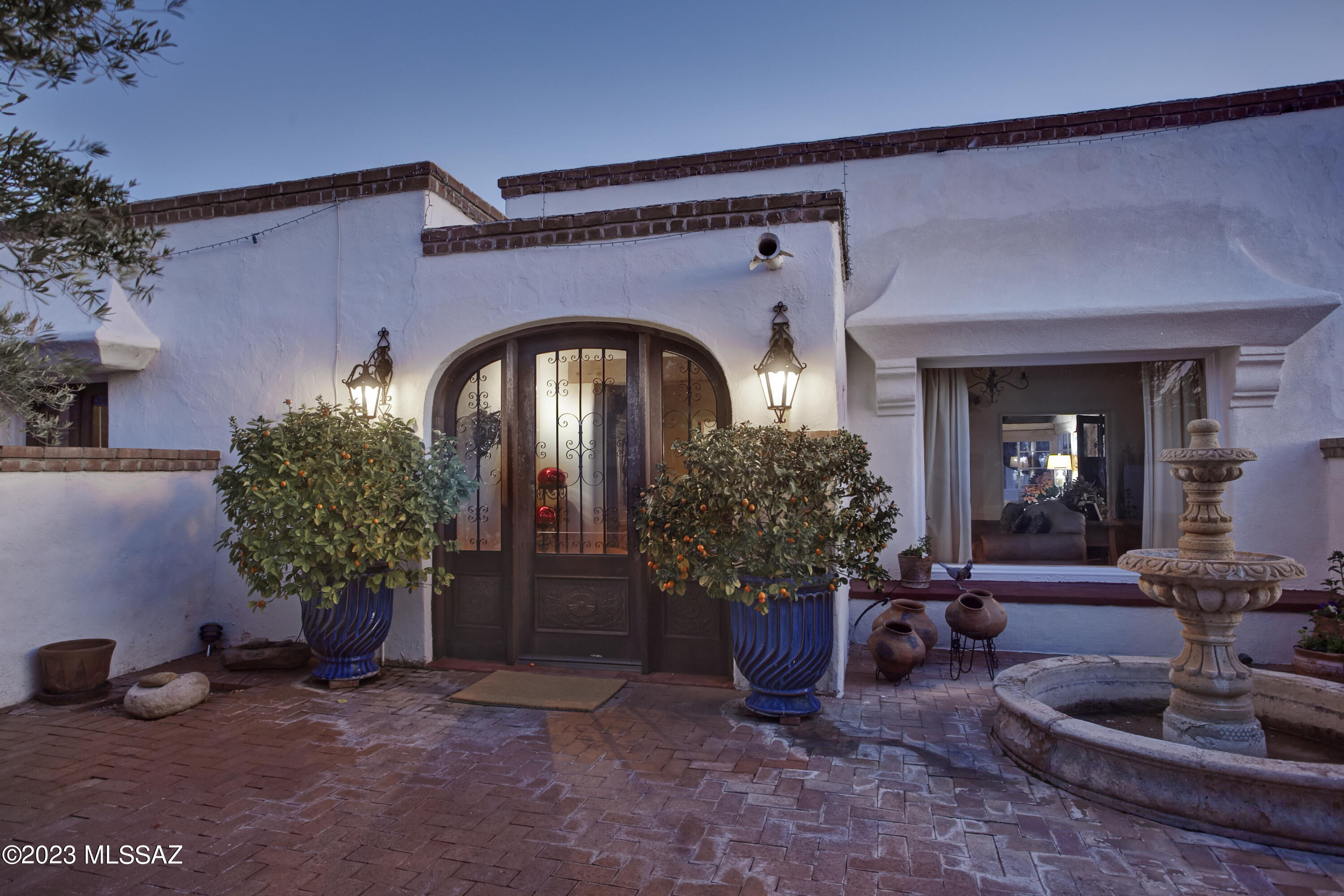 Charm and Character play the leading roles in this 1943 Joesler situated nicely on almost 4 acres in the ''old'' Catalina Foothills Estates. Known for his polished concrete floors, beamed ceilings, windows framing the desert /mountain views, multiple fireplaces and colorful Mexican tiles, this one will not disappoint! An intimate courtyard entrance leads into this old world classic. Delightful patio with pool and mature vegetation including orange ,lemon and grapefruit trees. Main house  includes 3 bedrooms plus separate 2 bedroom guest house with kitchen , living room with fireplace bath. Guest hse has separate entrance but is attached to one of the two car garages.
This property is horse property adjacent to a wash.