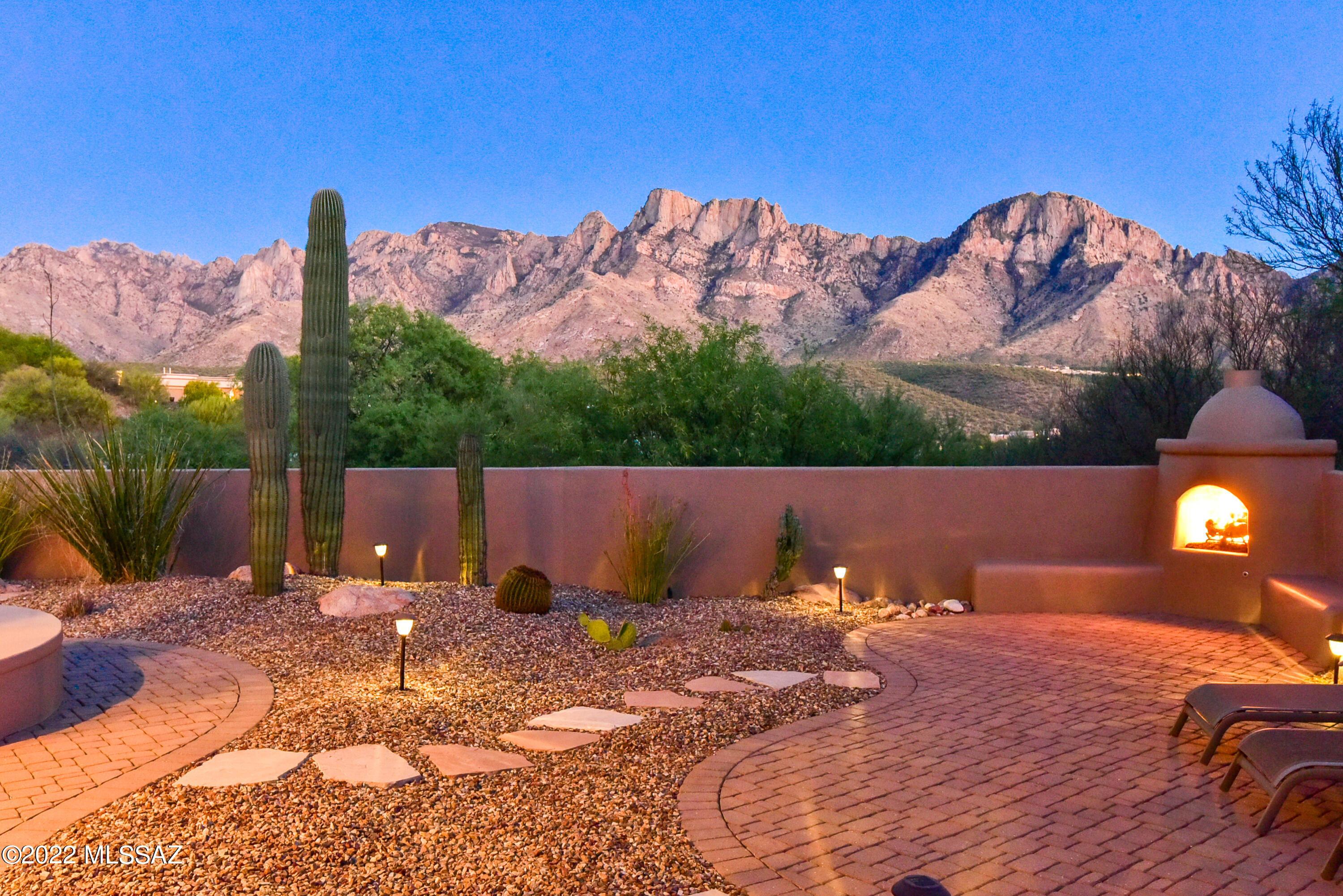 Gorgeous custom home located in the gated community of Palisades Point Estates that will not disappoint. As you walk through the custom front door the amazing views of the Catalina Mountains will mesmerize you. This amazing home features a great room concept with Bee Hive Gas Fireplace, gourmet kitchen with with sit up bar, kitchen nook, split bedroom concept, romantic master with walk in closet that will impress, spacious master bath with separate shower, garden tub, dual sinks and lots of storage. Guest Quarters with own bathroom and another wing with 2 bedrooms and separate bath. The outdoor patio area is an entertainer's dream with gas fireplace, separate seating areas to gaze at the Catalina Mountain from sunrise to sunset to view the ever changing colors. Don't miss this fabulous hom