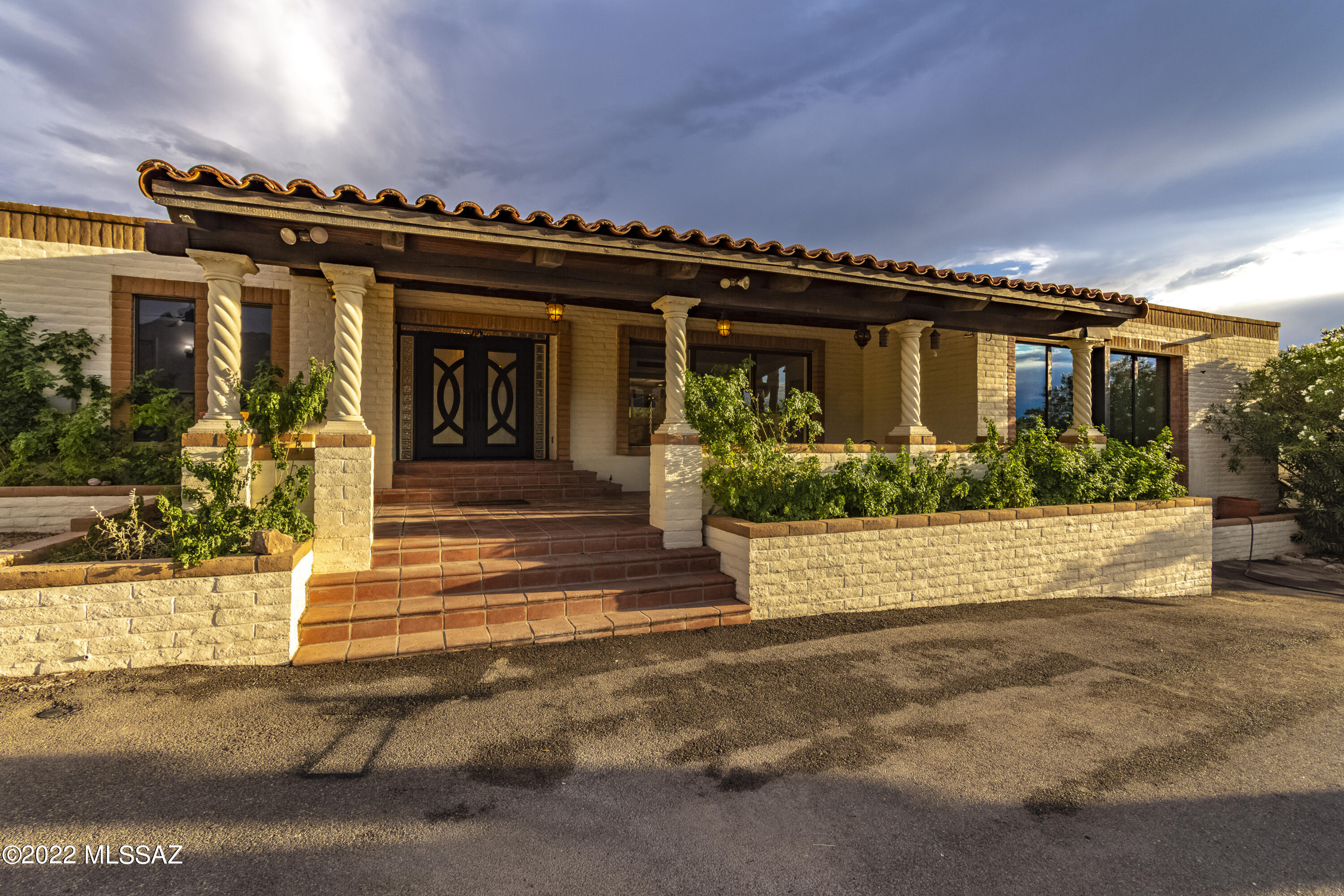 For your consideration, 
A freshly remodeled and updated Catalina Foothills classic. 
At nearly 5000 sq ft this dwelling is a true Territorial with traditional Mexican influences woven throughout.
This estate rolls over 1.5 acres estate of rolling desert . The home stands parallel to the Catalinas creating symmetry, a sense of permanency and anchoring it as the cornerstone of this premier Foothills neighborhood.  
You are greeted by the home's dramatic porte cochere  and center entrance, a unique design element rarely seen in the Foothills  architectural landscape. The home was thoughtfully designed over time and finally completed in 1976 with a flowing floor plan that lures families together for al fresco dining, entertaining, relaxing and recharging. The natural indoor outdoor flow invites people for gathering and celebrating as well as finding quiet, restorative moments tucked away from it all.  A private golf course keeps you at the top of your game.

A beautiful new island kitchen with quartz waterfall opens to the impressive great room.  Luxury Jenn-Air appliances.  The kitchen provides a spectacular view of the Catalina Mountains as well as overlooking the AUTHENTIC Mid Century Modern great room below. 
It's 13' tall original rare wood clad walls, floor to ceiling lava stone fireplace and exposed brick are the trifecta of MCM design. You can enjoy views of the mountains from the formal dining room and then cozy up to the fire in the adjacent den for dessert.

The home offers six bedrooms, 2 with built in lofts and 4 baths with many options for work, play, exercise, meditation, creativity and more. 

The primary bedroom is situated at the end of a long passage that harkens back to Frank Lloyd Wright's embrace and release design technique to illicit a sense of levity and quiet tranquility upon entering the primary living quarters. This sanctuary reveals itself further as a luxurious wing with its own outdoor access. The main bedroom offers instant serenity with soaring sun drenched brick walls and a stunning hand carved fireplace. On your way to the original authentic Mexican tile adorned ensuite you will pass through a grand dressing lounge and dedicated make-up room with endless built in space that rivals any 5th avenue department store. 

The guest house welcomes visitors as well as offering an opportunity for multigenerational living. 

The grounds were designed for entertaining poolside, relaxing in the spa, hitting golfballs, grilling out or just enjoying the monsoons under one of the many covered areas. 

Should you ever decide to leave your private oasis you are situated steps away from hiking and biking trails as well as a 20 minute walk to some of the finest restaurants and shopping the Catalina Foothills has to offer.

You are in Tucson's number one school district CFSD 16.
The surrounding homes are lively with many young families as well as a few of this charming neighborhood's original residents.
