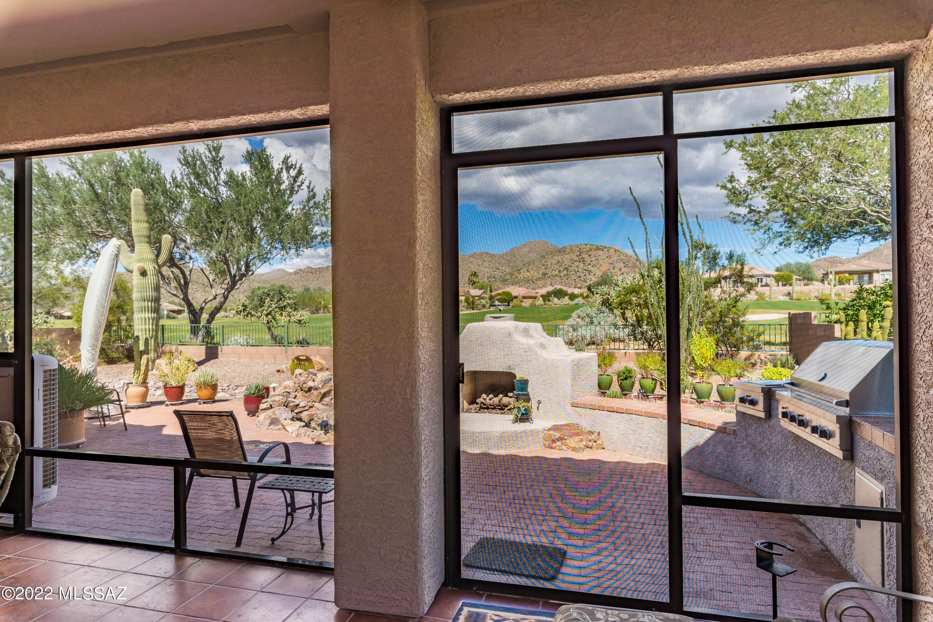 Spectacular Santa Barbara model w/3 full bedrooms + den + built-in office area + an extended garage & golf cart alcove (or workshop area). Fully screened & COOLED rear porch  w/2 exit doors. Immaculate condition. Owned solar system. Fully fenced yard w/water feature & bench, Viking built-in BBQ station, and outstanding panoramic golf course & mountain views.  Right side of home is  brick paved - very nice feature. Owned solar system. Extended garage has abundant built in storage cabinets, wall storage & workshop area.  The guest bedroom wing has private pocket door creating a full dual suite experience.  Den has built in entertainment shelving & storage. 3 bay windows, tiered ceilings. Home has a plethora of upgrades including a few unique pocket doors and is in immaculate condition.