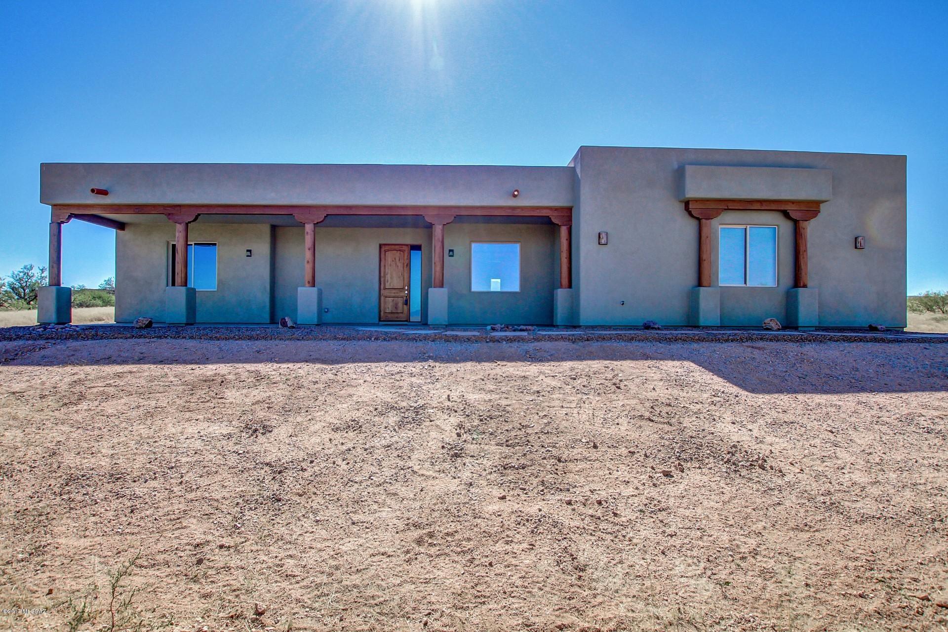Lovely Santa Fe on nearly 3 acres located in one of Arizona's best kept secrets, Red Hawk at J-6 Ranch!  Come see the gorgeous views & rolling grass land nestled near the base of the Whetstone Mountains. Built in 2016, this home features a spacious, open great room floor plan, soaring ceilings, vega beams, beautiful chiseled edge travertine tile floors, huge entertainer's kitchen includes all appliances, self closing cabinets, large work island, bar seating for 5, granite counter tops and walk in pantry! Enjoy the indoor/outdoor lifestyle with large covered front porch and rear patios. Recessed & lighted ceiling in formal dining.  Spacious master suite, his and hers closets, beautiful walk in shower and soaking tub. Views*Privacy*Space!