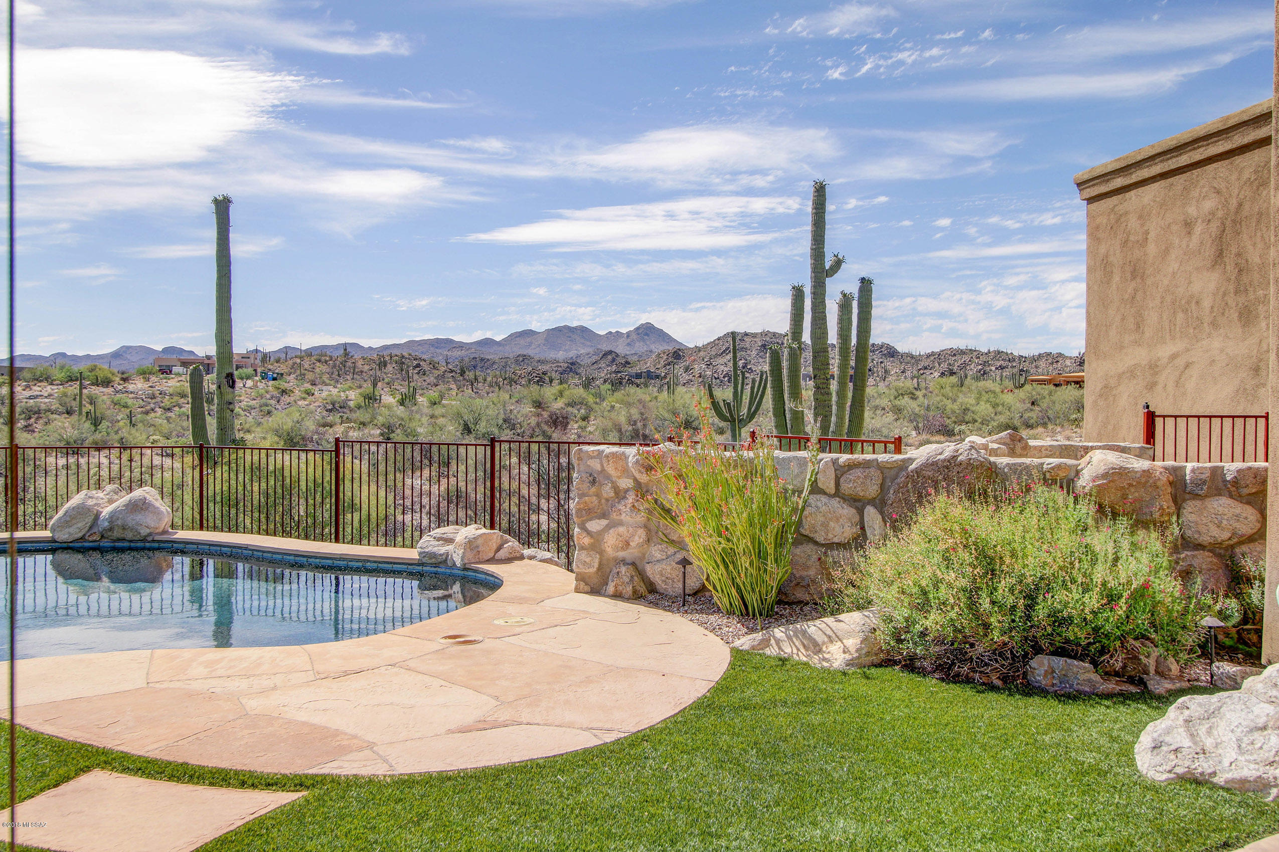 Stunning custom home in gated Honey Bee Canyon Estates sitting on elevated cul de sac lot with Catalina and Tortolita Mountain views. True gourmet kitchen with sit up granite center island, Viking appliances including three ovens, 2 dishwashers, 2 microwave ovens and wine refrigerator. Marble and wood flooring, built in wine cellar, fireplaces in living and family rooms and entertaining patio with outdoor kitchen, fireplace and solar heated salt pool. Exceptional finishes and quality construction on two plus acre homesite!