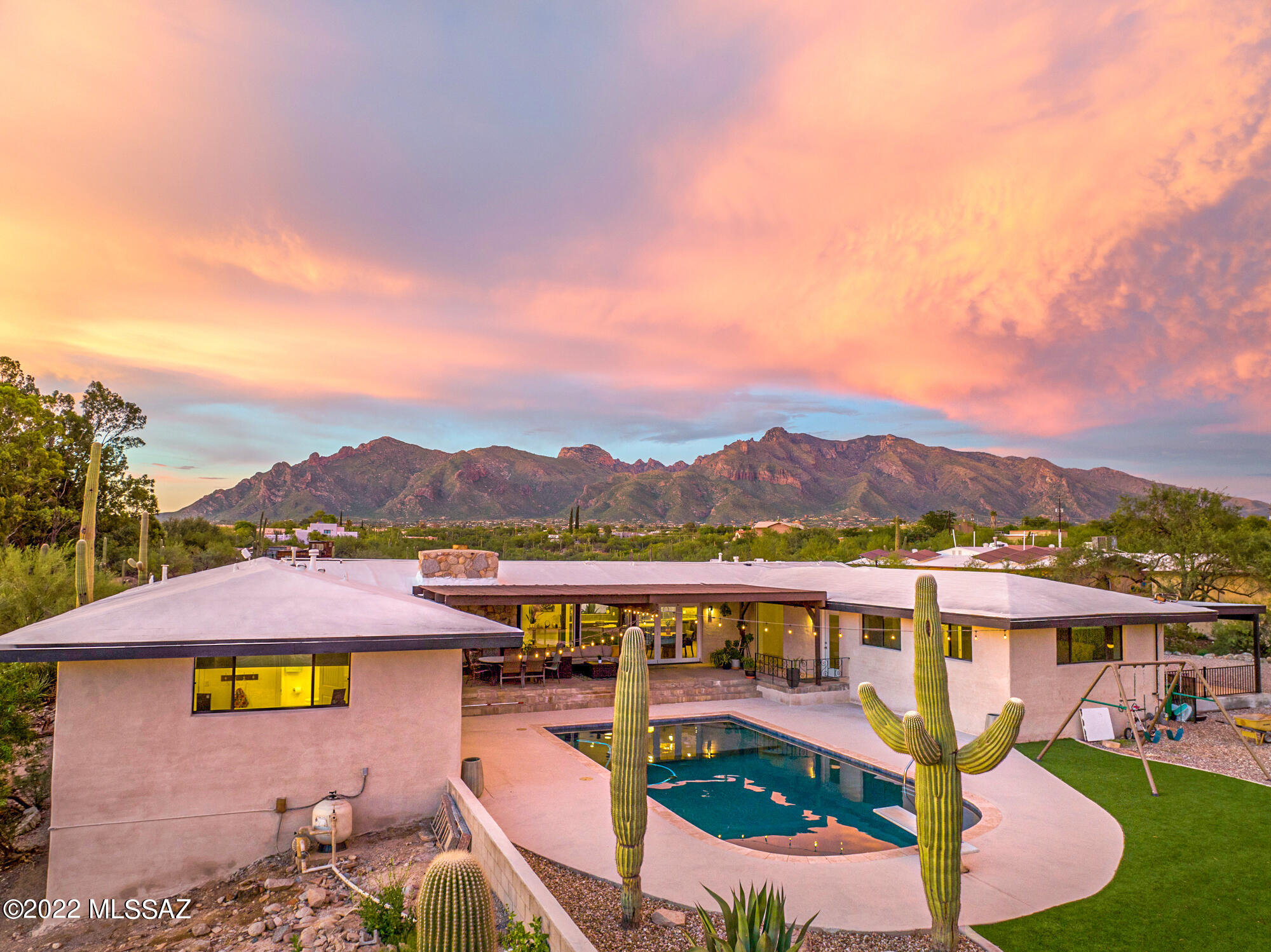 Welcome to the most stunning panoramic mountain view's, remarkable sunsets and twinkling city lights that this mid century adobe home has to offer. Situated on 1.89 acres of pristine Sonoran desert in the highly coveted Oracle Foothills Estates. This 4 bed 4 bath plus office/den went through a complete gut renovation completed in 2020 including a new roof, all new; plumbing, electrical, drywall, interior framing, insulation, recessed lighting, support beams, doors, windows, custom cabinetry and the list goes on. The gourmet kitchen is equipped with Bosch appliances, luxury Cambria Quartz countertops, deep cabinet sliding drawers and a large island with seating for four. The unique U shaped floor plan boasts a primary suite and office that are separate from the remaining 3 bedrooms. Two of the three guest bedrooms offer private ensuite baths. Accordion glass doors open up to the back patio for the most dramatic views and ultimate indoor outdoor living. The backyard was extended and updated to include a redesigned PebbleTec pool with built in umbrella holders and custom sitting stools. Ideally located within minutes to everything. Ample parking and no HOA. Come experience everything this private desert retreat has to offer. One seller is a licensed real estate agent in the state of Arizona.
