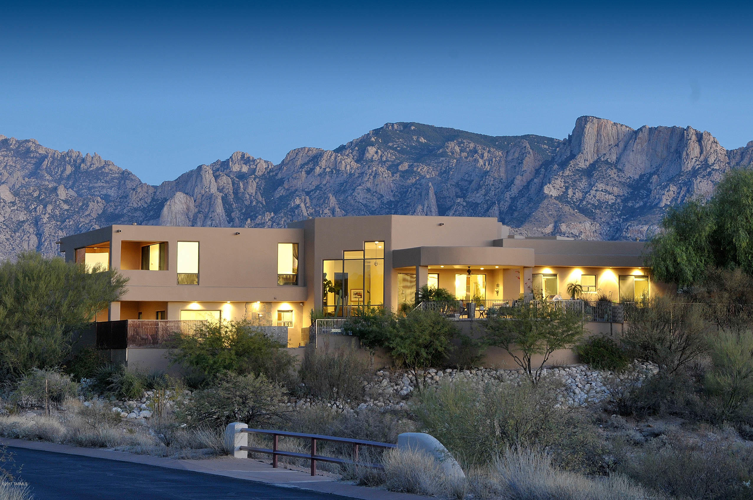 Stunning Desert Contemporary Ultra-Custom Residence on a lush 1.19 acre lot with Mountain, Sunset and Desert Vistas on a private quiet cul-de-sac. Open effortless floorplan to capture the Tucson lifestyle designed for indoor and outdoor entertaining. A perfect blend of quality finishes including Travertine floors, custom lighting, top-of-the-line stainless appliances, indoor cascading waterfall entry wall, surround sound, floor-to-ceiling window walls to capture the views from every room. Spacious outdoor living with spectacular pool/spa, built in BBQ + outdoor shower, firepit and expansive covered patios. 5 bedrooms + nursery/study with closet, oversized 3 bay garage, all the amenities . . . turn-key ready for immediate occupancy